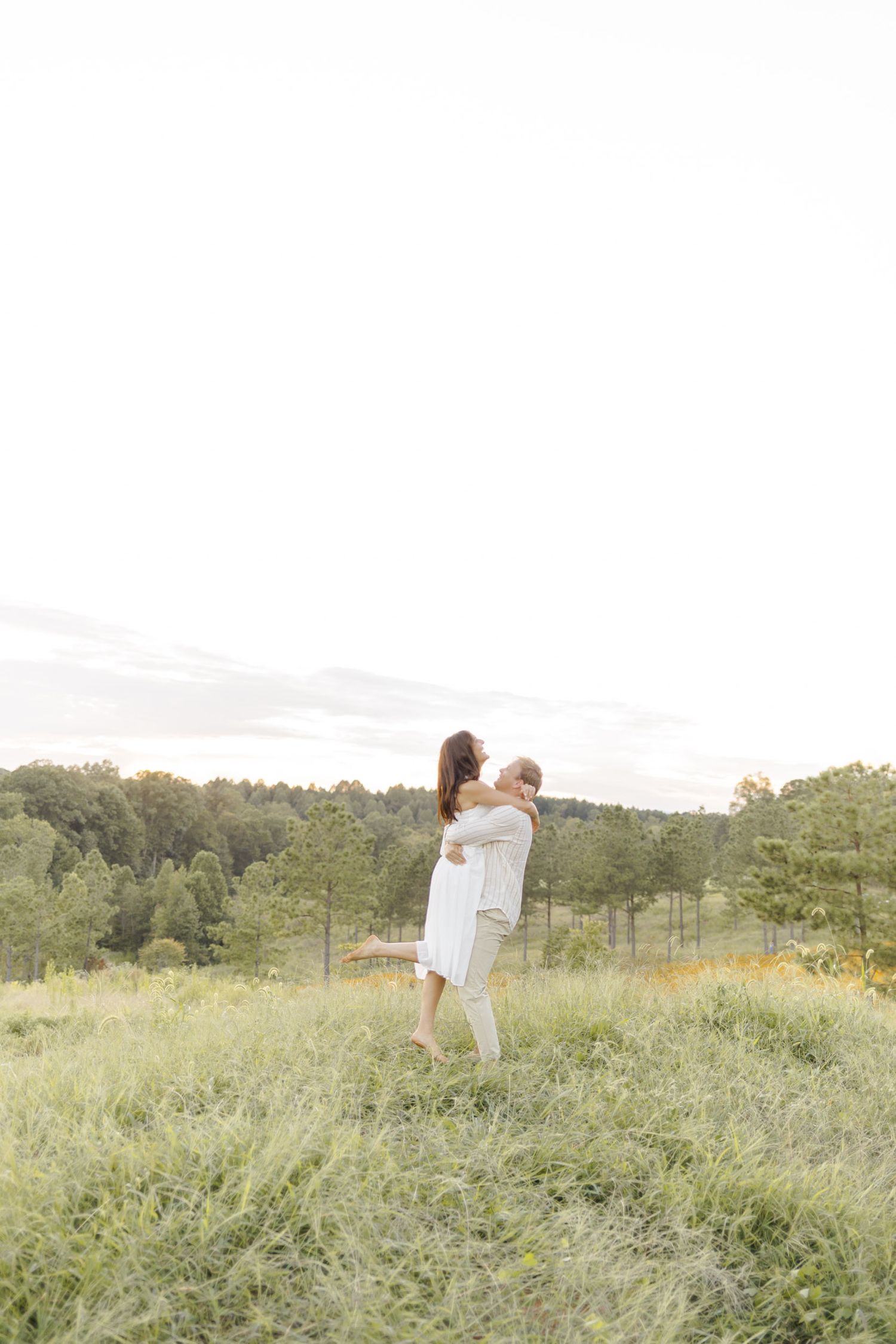 Playful dance sequence in wildflower field with mountain backdrop making a light, airy, creamy picture in Chapel Hill, NC