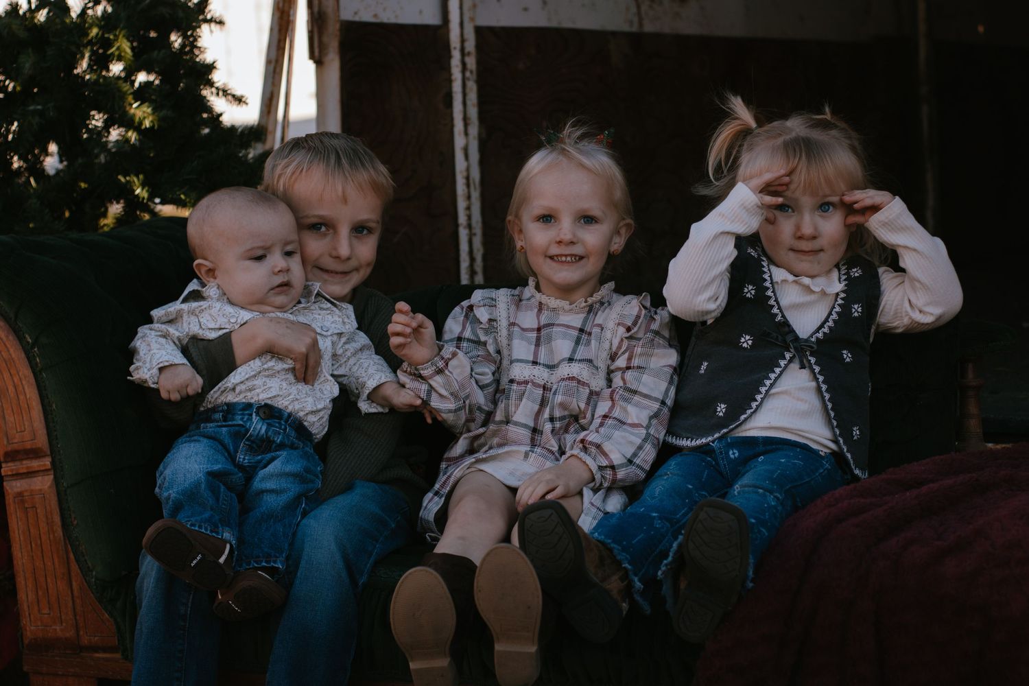 4 children on green couch