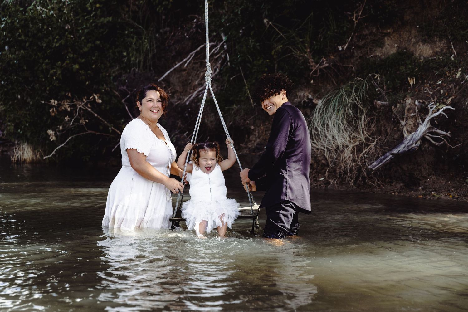 Manly, Hibiscus Coast Family Photography: mum and her children enjoying a swing in the water, Auckland North Shore session.