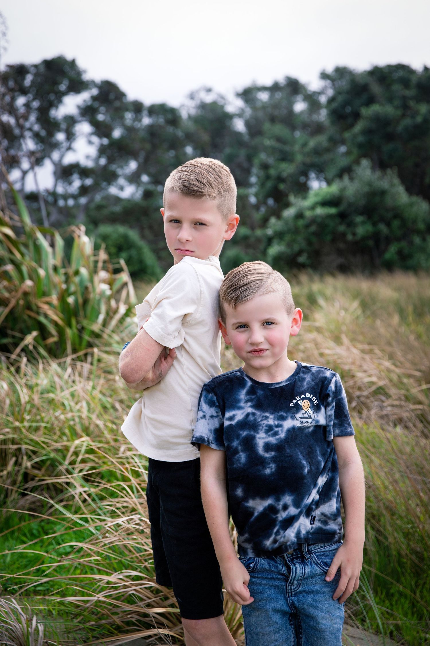 Wenderholm Beach Family Photoshoot: Candid photo of two brothers enjoying nature, Auckland Rodney session.