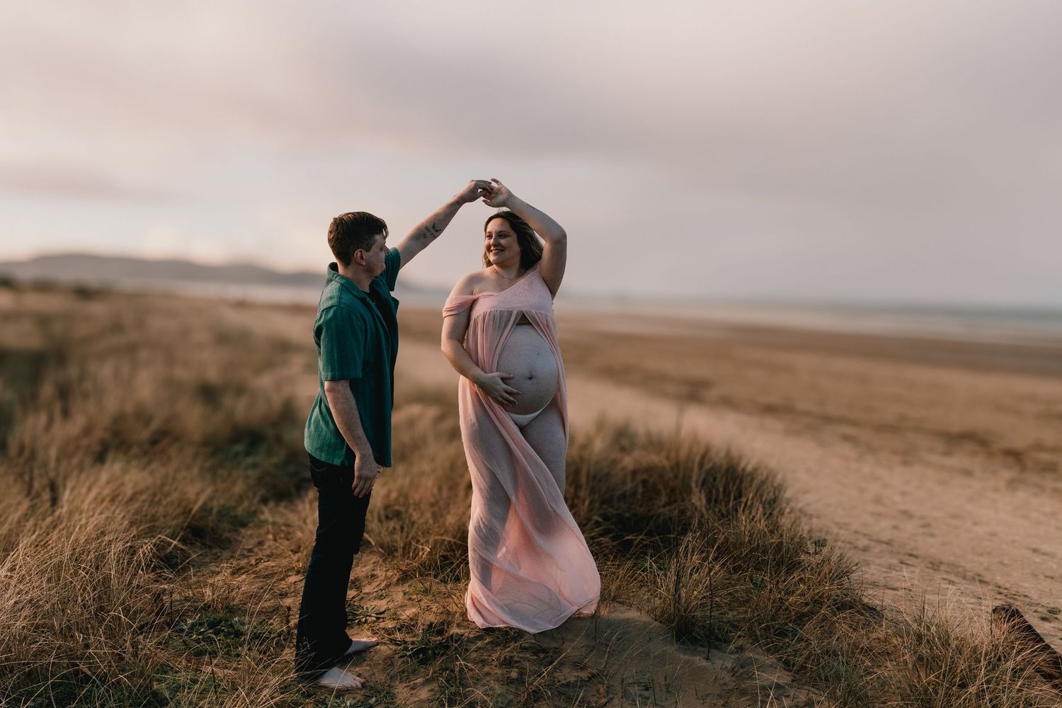 Orewa Beach Wedding Photographer: Couple dancing on the sand during golden hour, Auckland North Shore wedding.