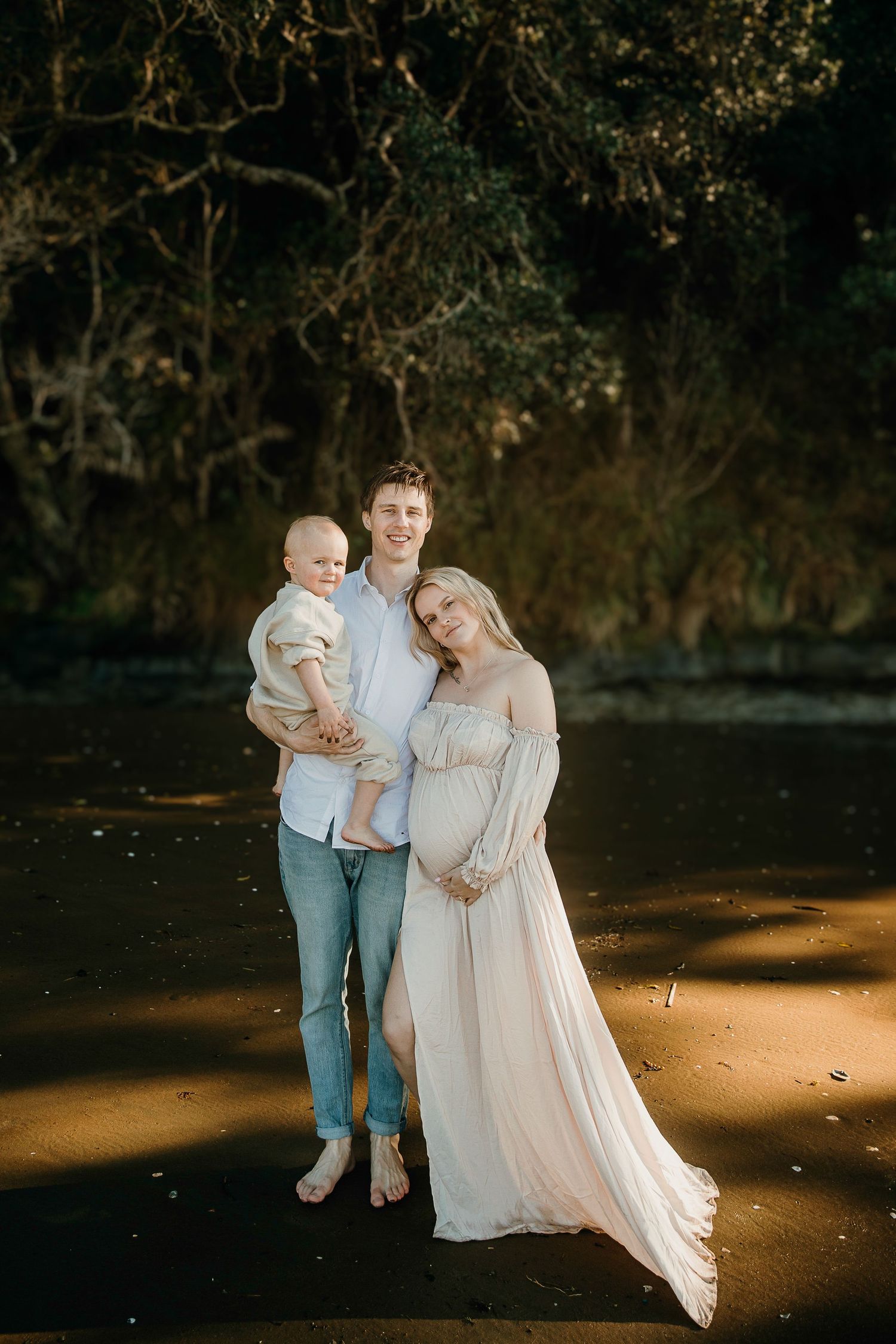 Auckland North Shore Family Maternity Portrait: Mum, dad, and son portrait at sunset on the beach.