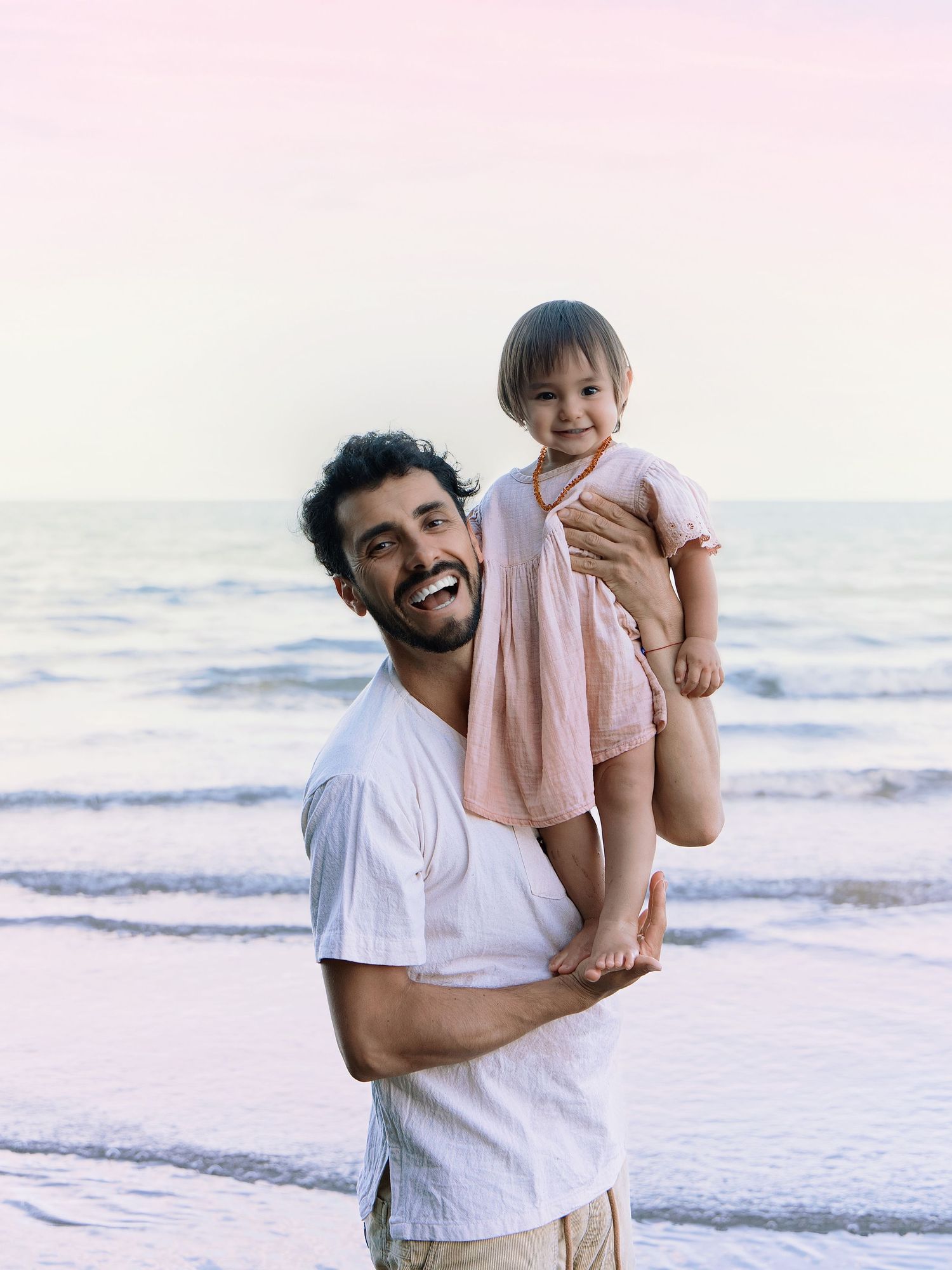 Dad holding daughter during Sunset at Long Bay beach, Auckland family photographer, Shara-lee Photography