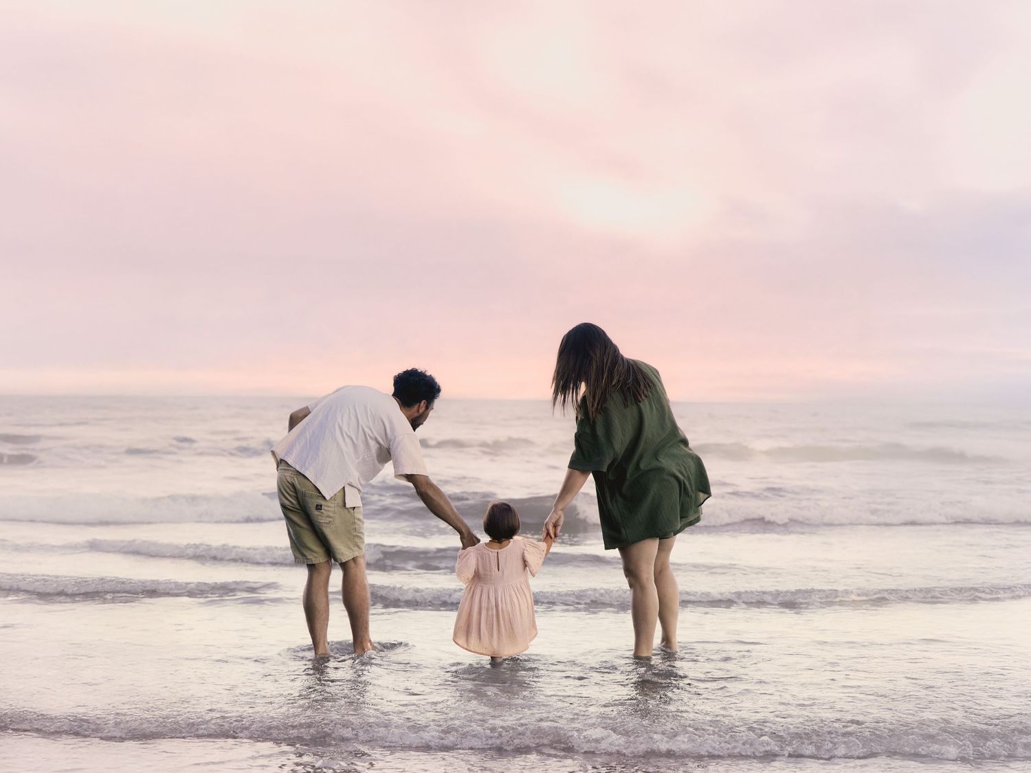 Family playing in water during Sunset at Long Bay beach, Auckland family photographer, Shara-lee Photography