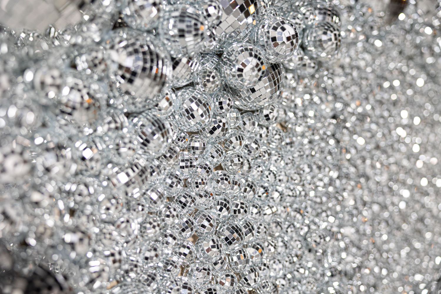 Extreme close-up of glittering silver sequined surface texture.