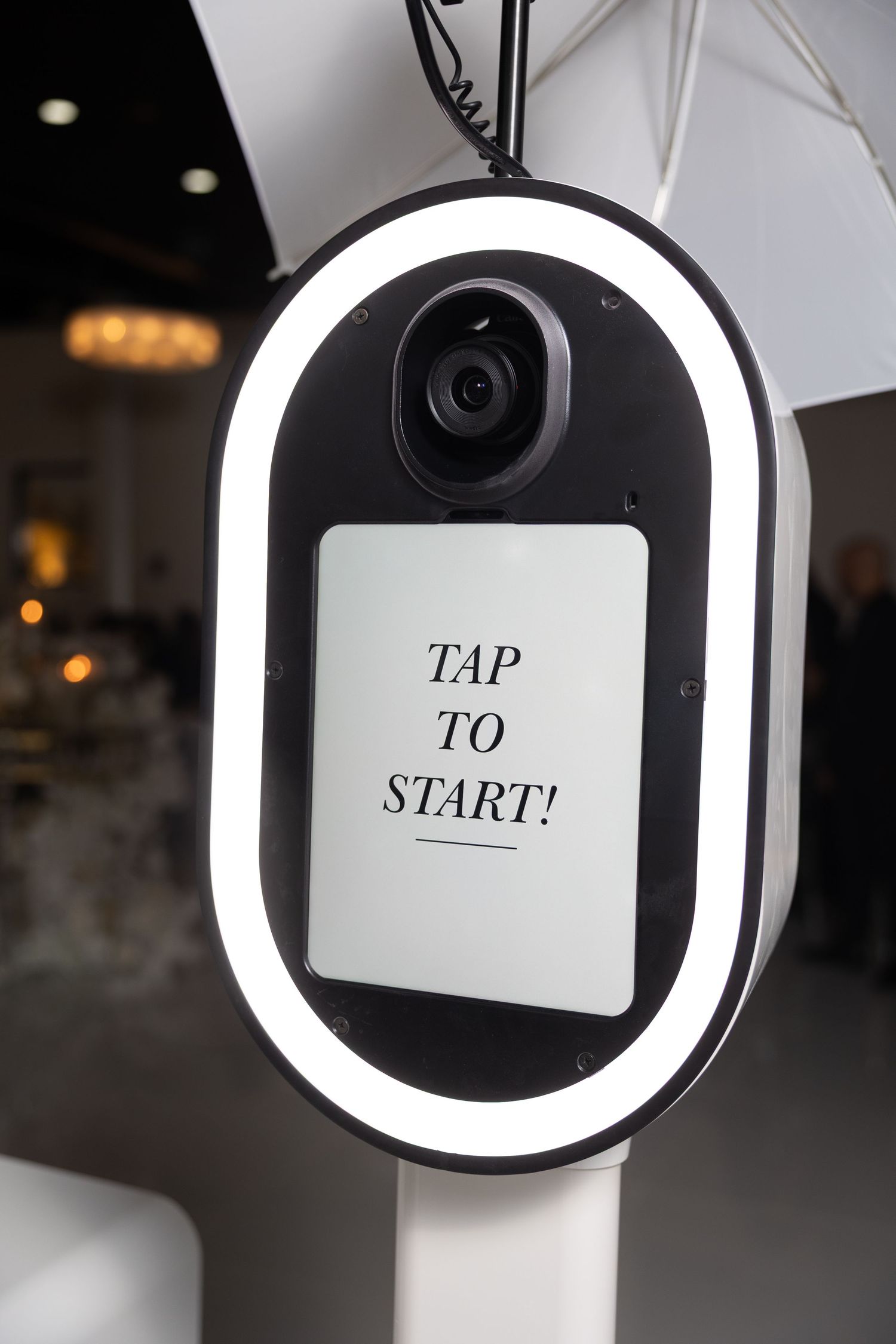 Close-up sequence of a modern photo booth display screen showing 'TAP TO START' text.