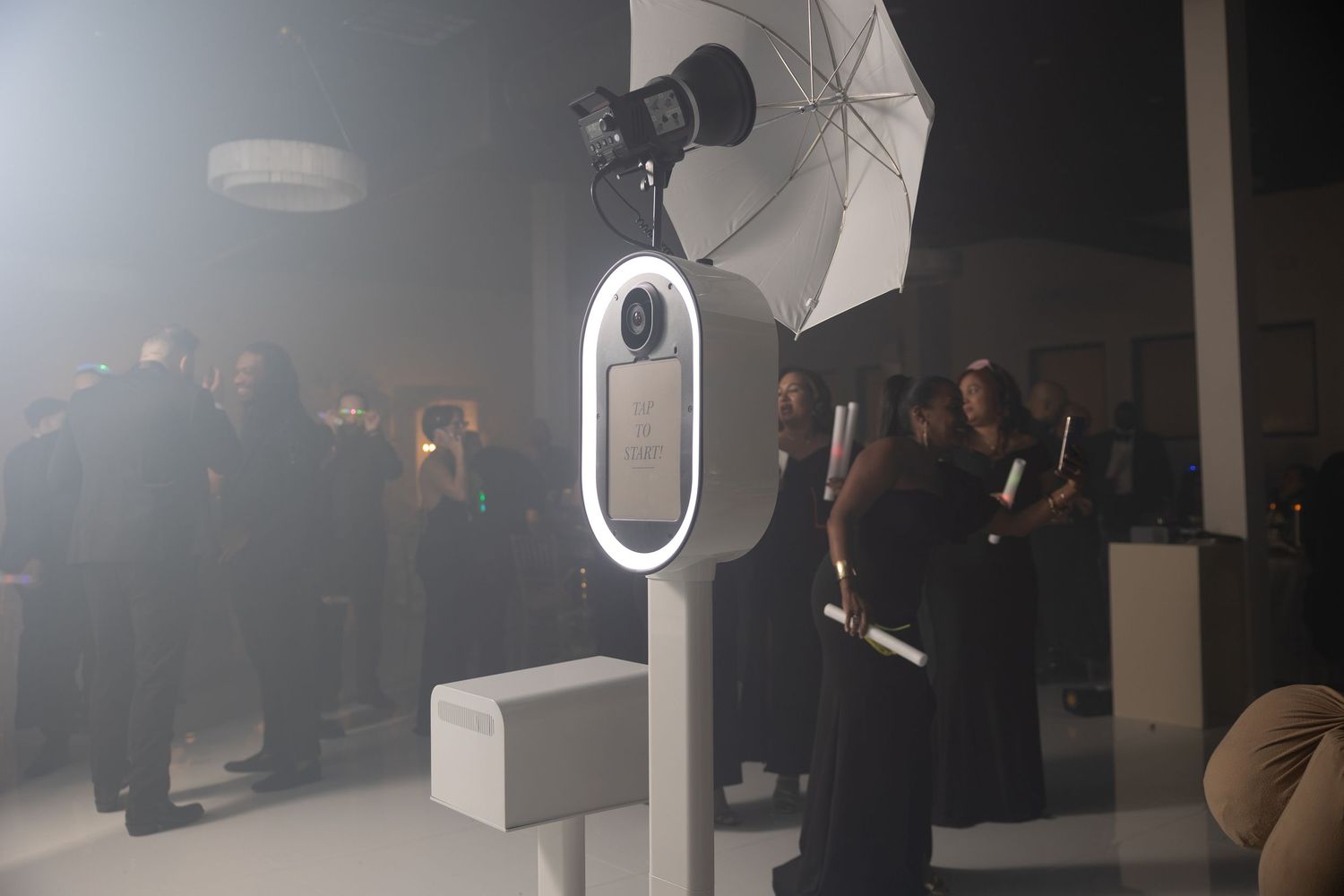 Dark studio environment with professional lighting equipment and umbrellas.