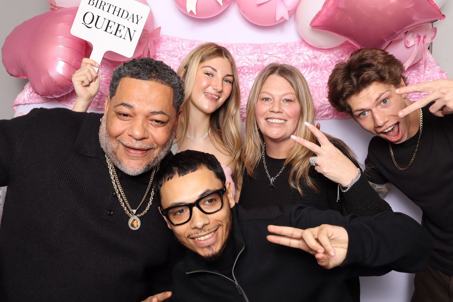 Photo booth strip showing festive party moments against a pink backdrop.