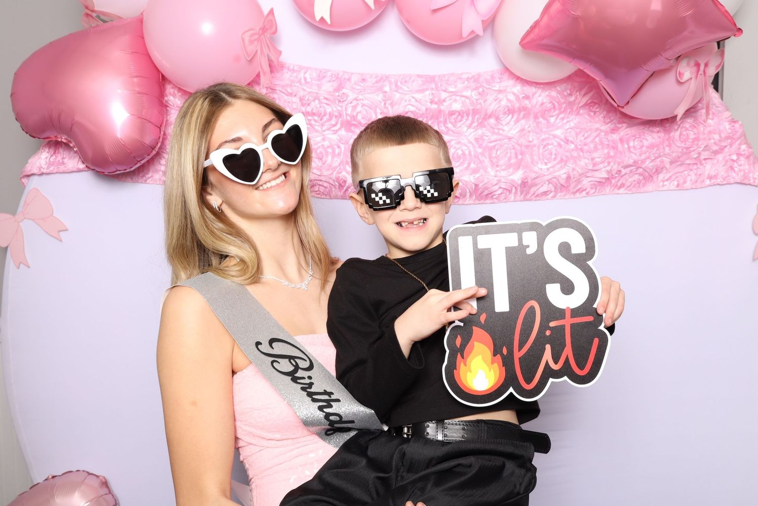 Photo booth strip capturing party moments with props and pink balloon background.