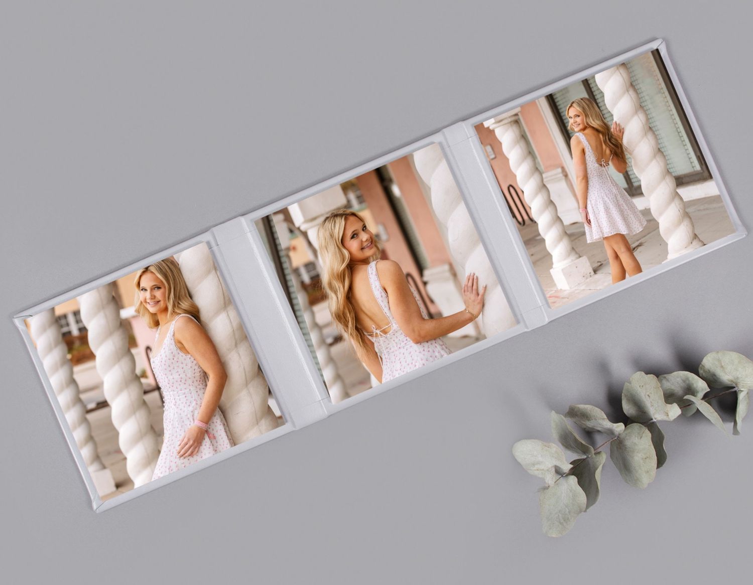 An open senior portrait photo album displaying three images of a blonde woman in a white dress.