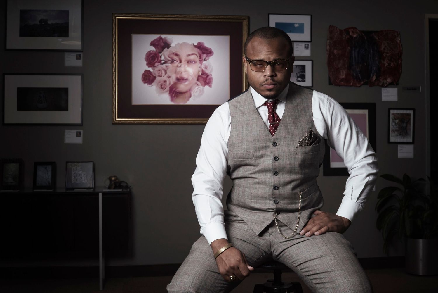 Environmental portrait of a man seated in a formal interior setting