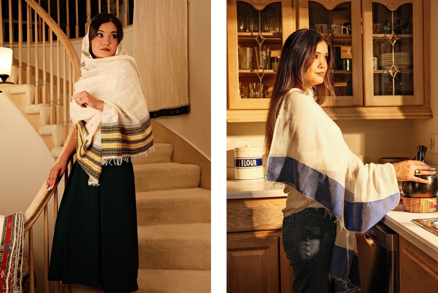 Woman in white fringed wrap shawl with stripe detail, styled over dark skirt, posing indoors near staircase and kitchen.
