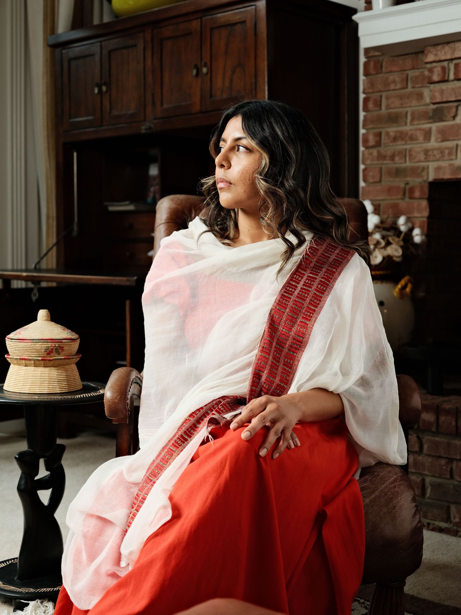 Woman seated indoors during a brand lifestyle portrait session