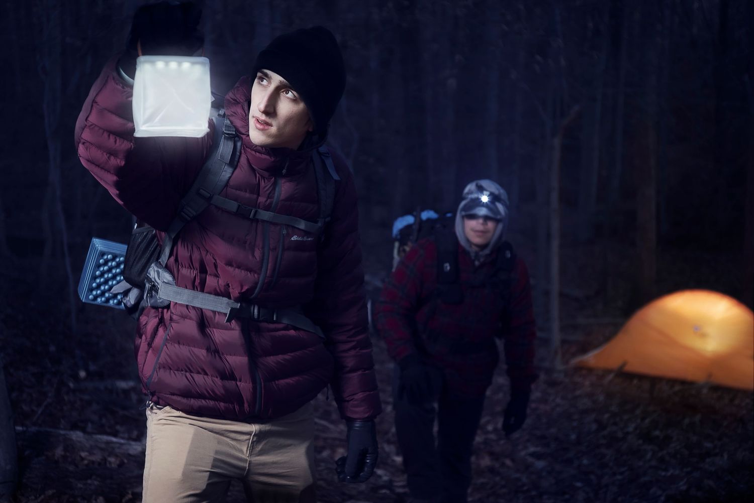 Cinematic portrait of two people outdoors at night with lantern light
