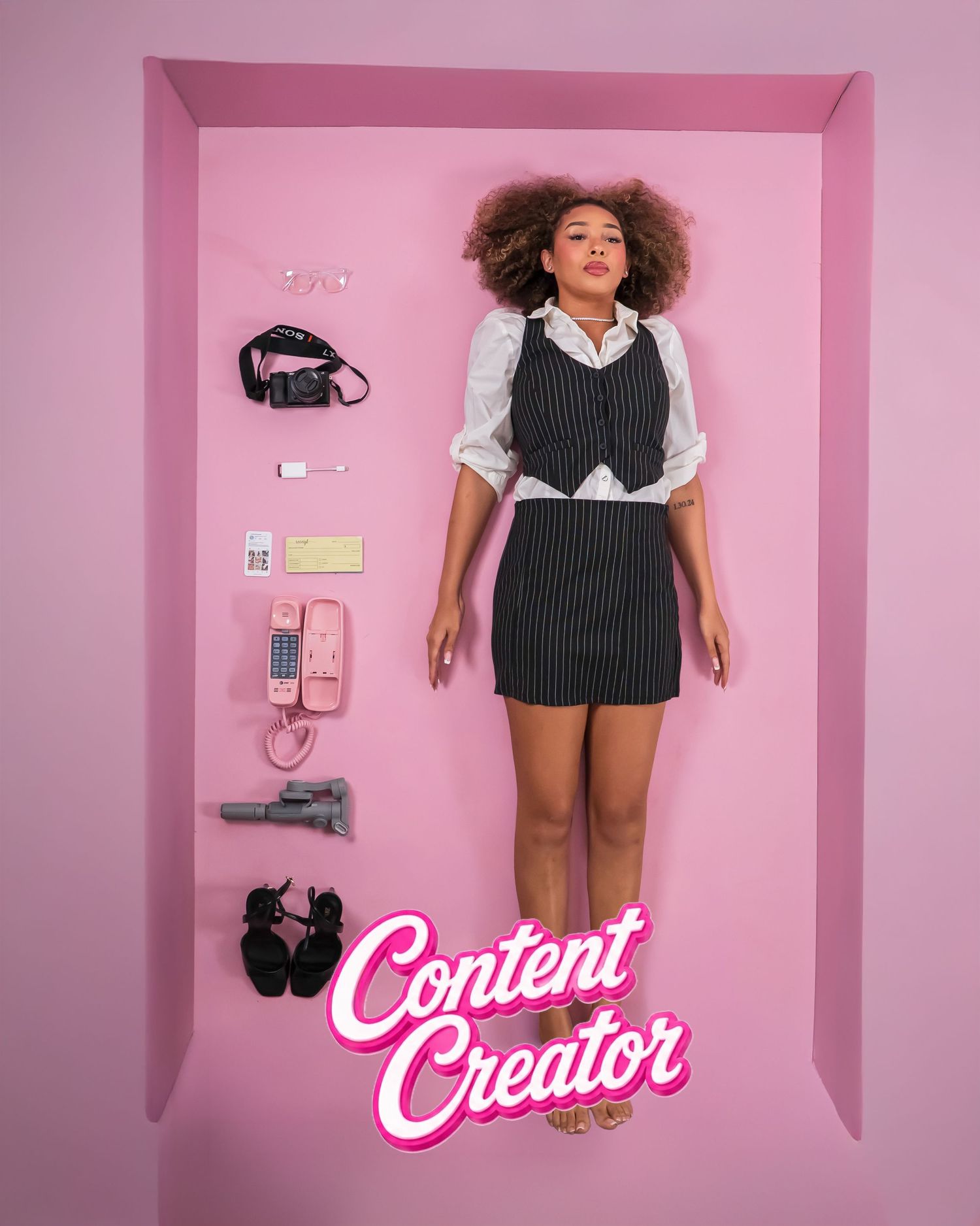 Woman posed in pink box display styled as a Barbie doll with Content Creator label and accessories.