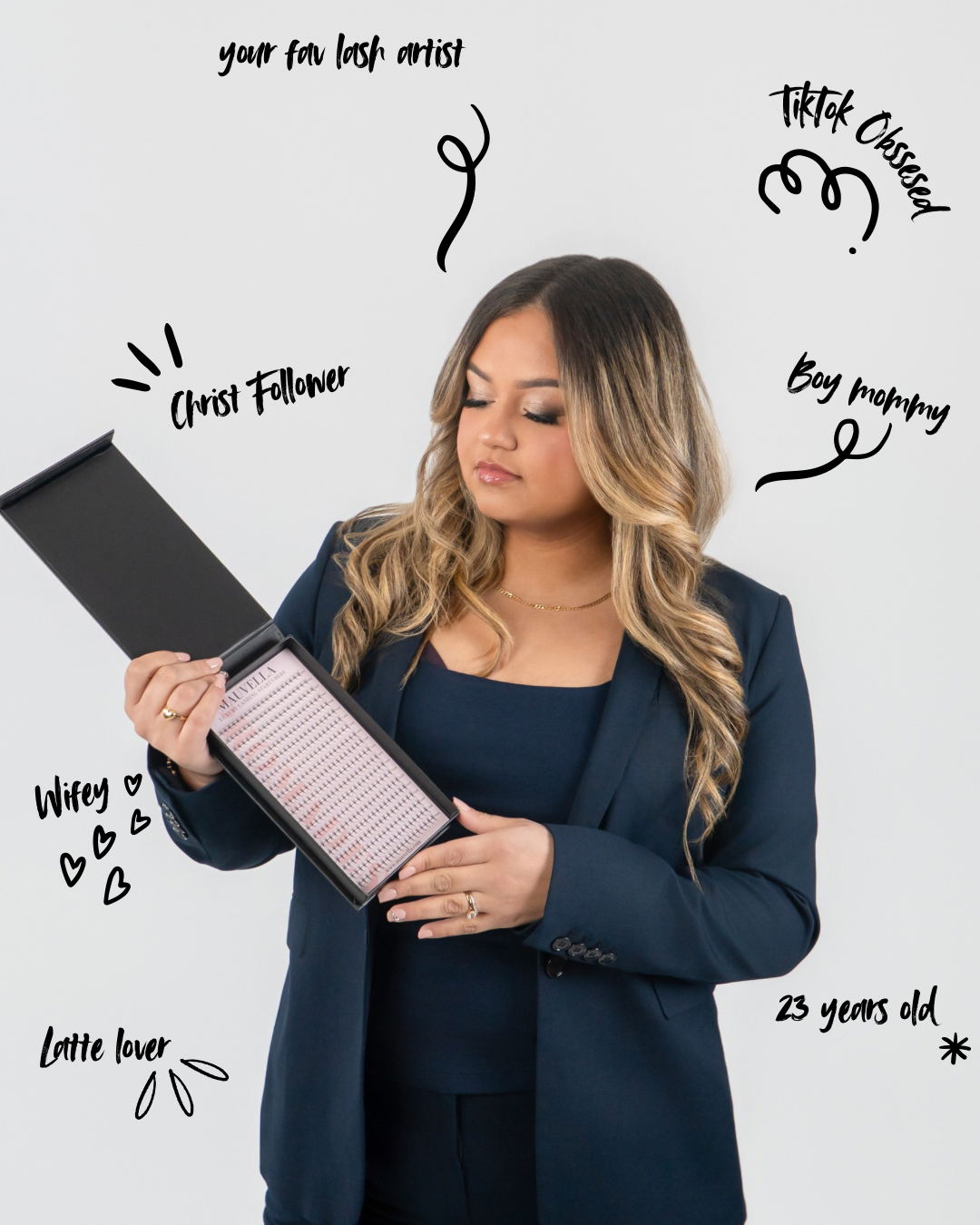 Woman in navy blazer holding a lash tray, surrounded by handwritten labels describing her identity and interests.