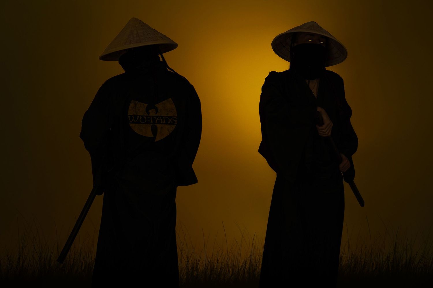 Two silhouetted samurai warriors in conical hats with Wu-Tang Clan logo, standing against a golden sunset sky.