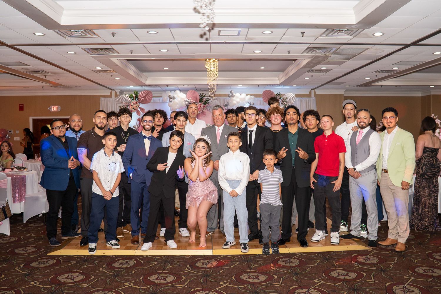 Large group of people posing together at a formal banquet hall celebration event. Sweet 16!