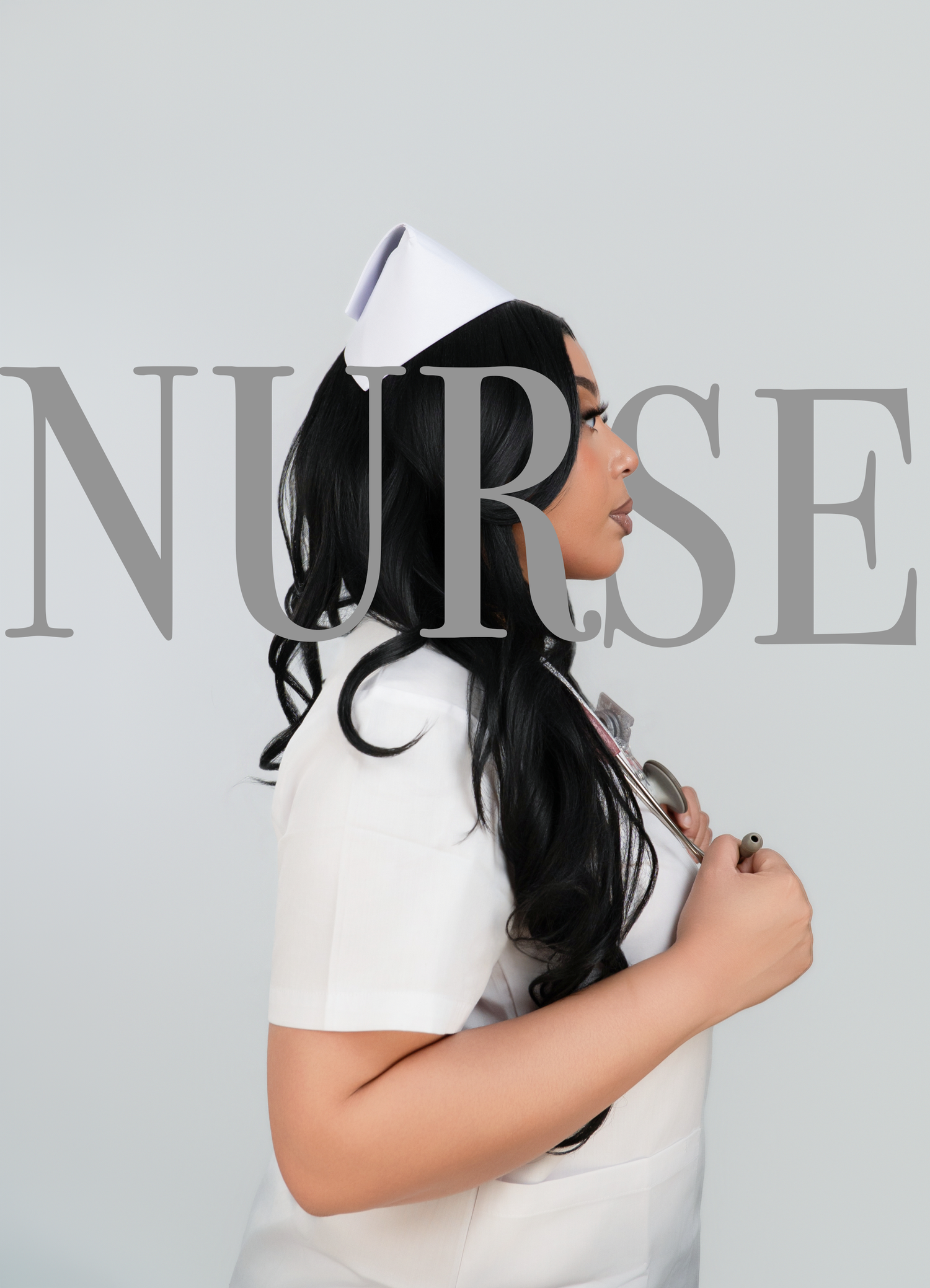A woman in a white nurse uniform and cap holds a stethoscope, posed sideways against a gray background.