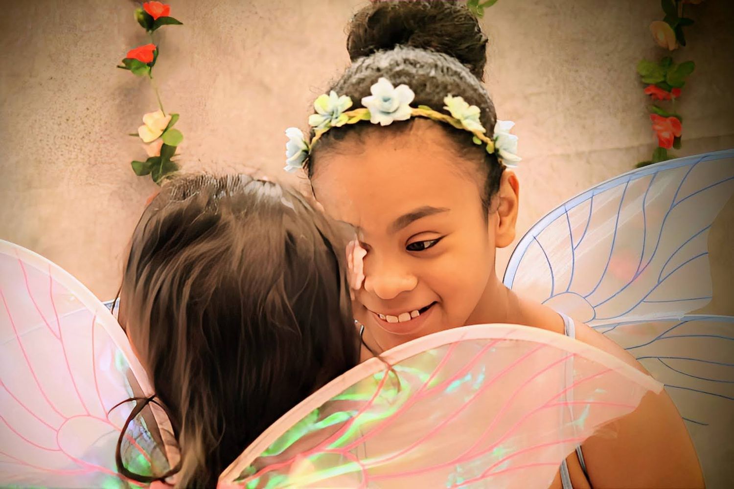 Fairy smiling at smaller fairy