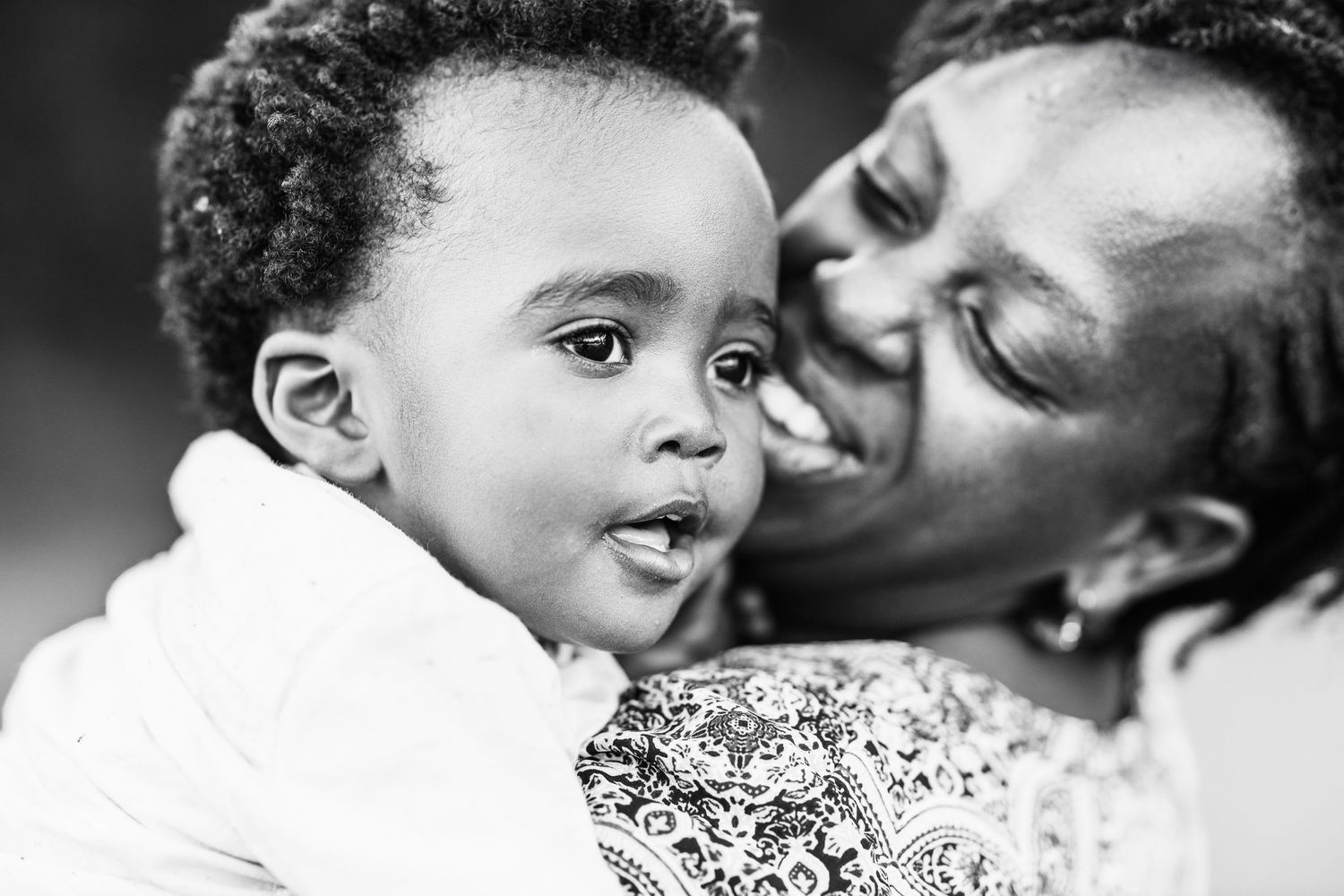 A candid moment of a mother and son smiling at each other at Karen Blixen, Nairobi, Kenya.The image captures connection