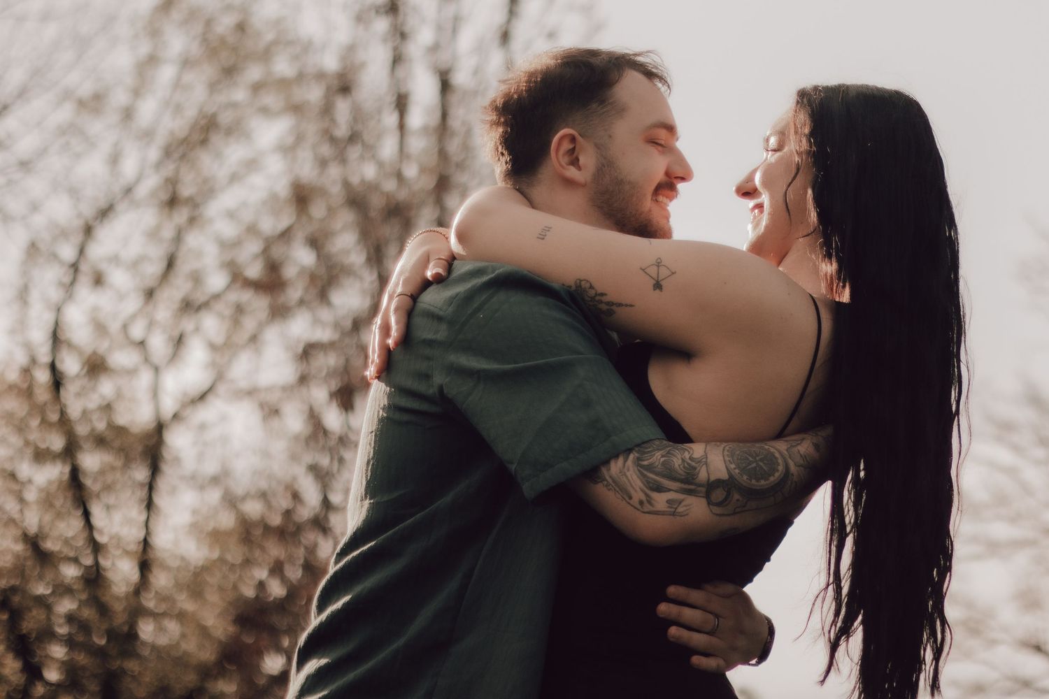 A romantic couple embraces tenderly in a series of intimate outdoor portrait shots.