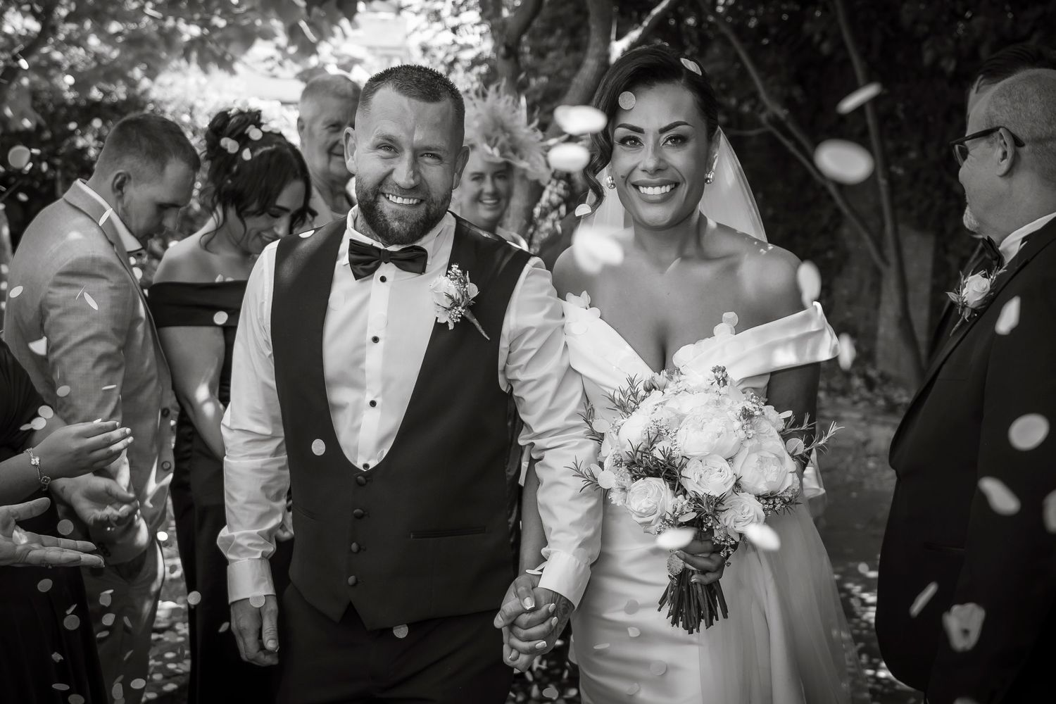 Black and white wedding photos capturing joyful moments between the couple and guests during celebrations.