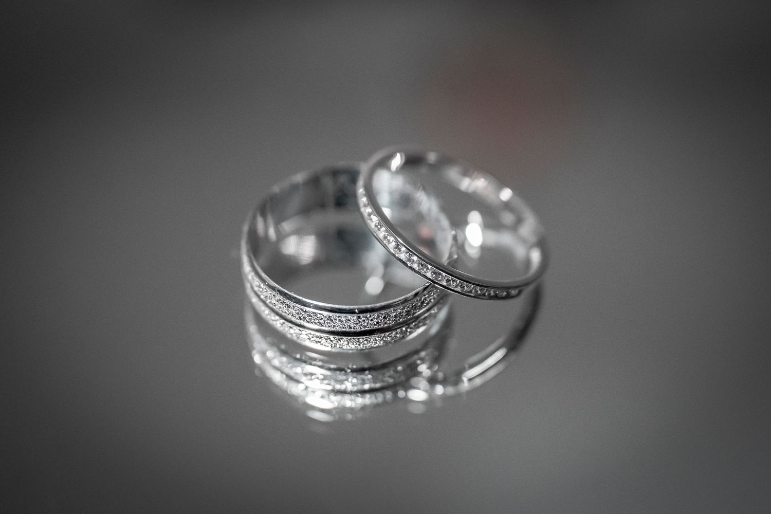 Close-up shot of silver wedding bands with shallow depth of field.