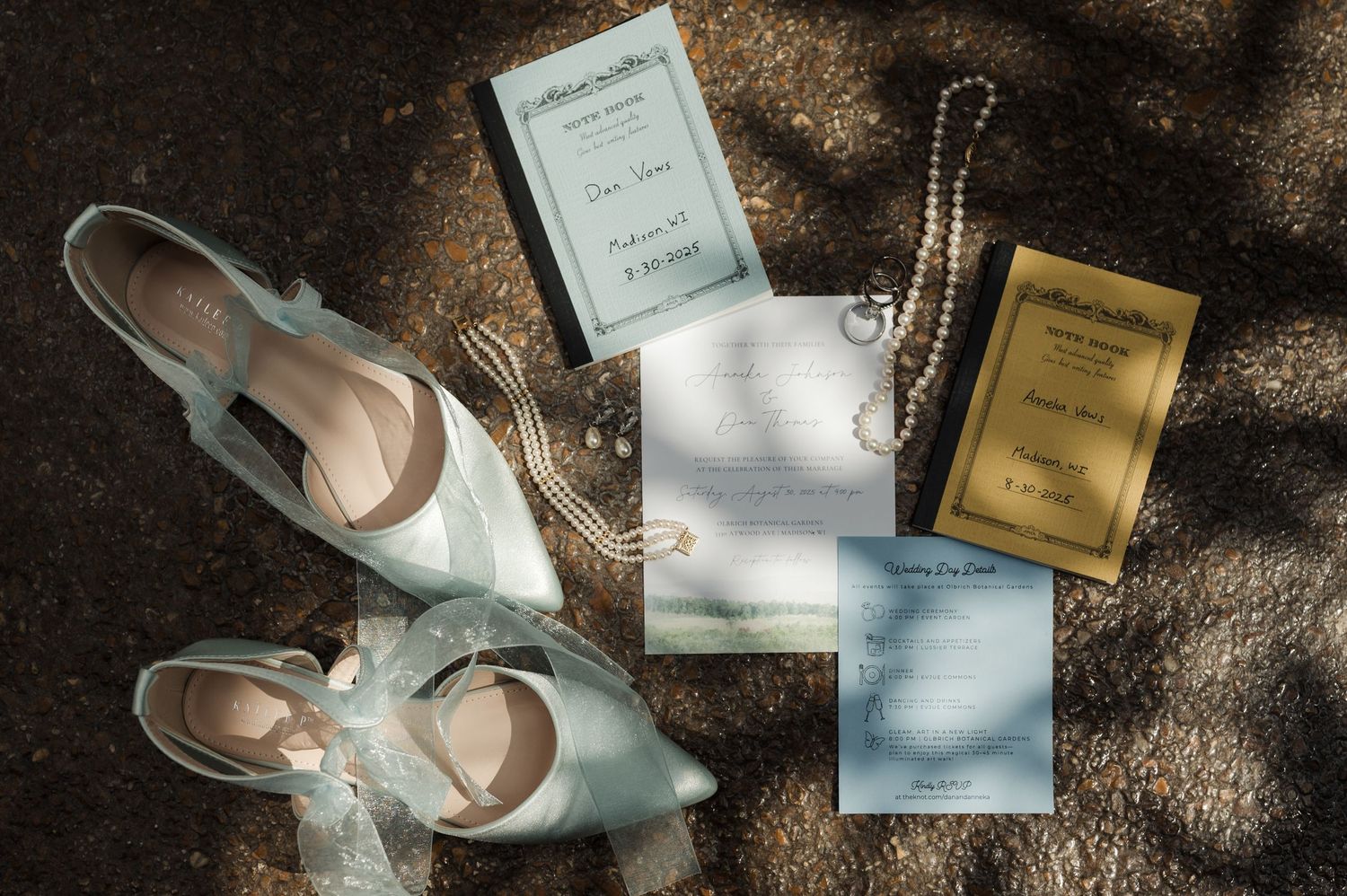 Elegant wedding flat lay featuring light blue bridal shoes, pearl jewelry, and gold and blue invitation suite.