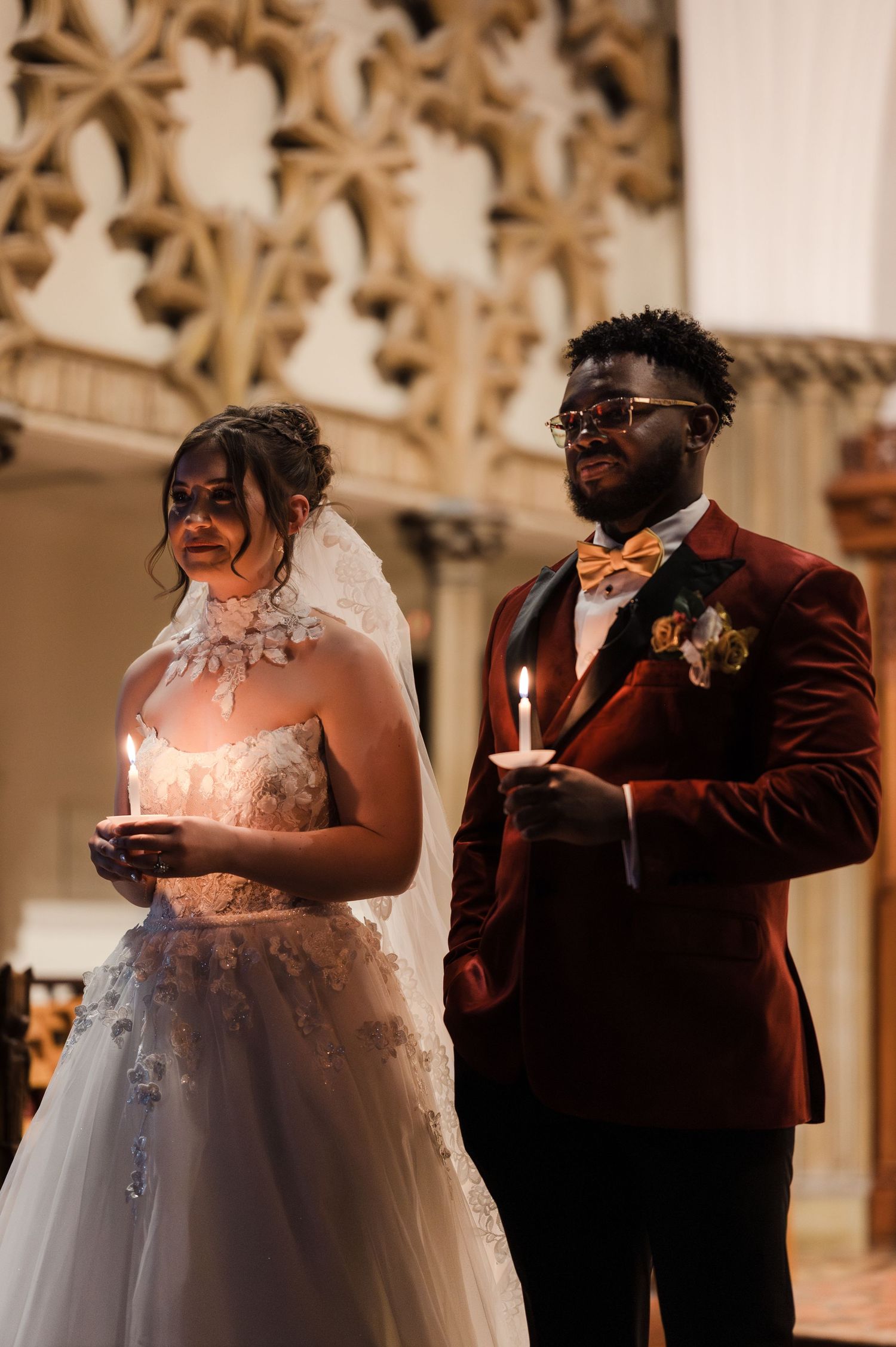 A couple shares an intimate moment during their wedding ceremony in a beautifully decorated church setting.