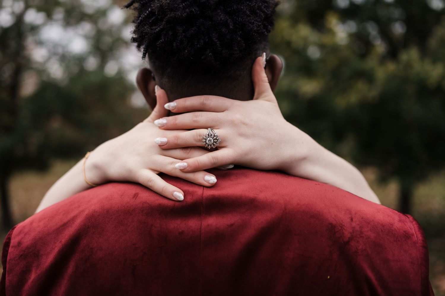 A series of cropped photos showing hands resting on shoulders and backs in intimate poses against dark backgrounds.