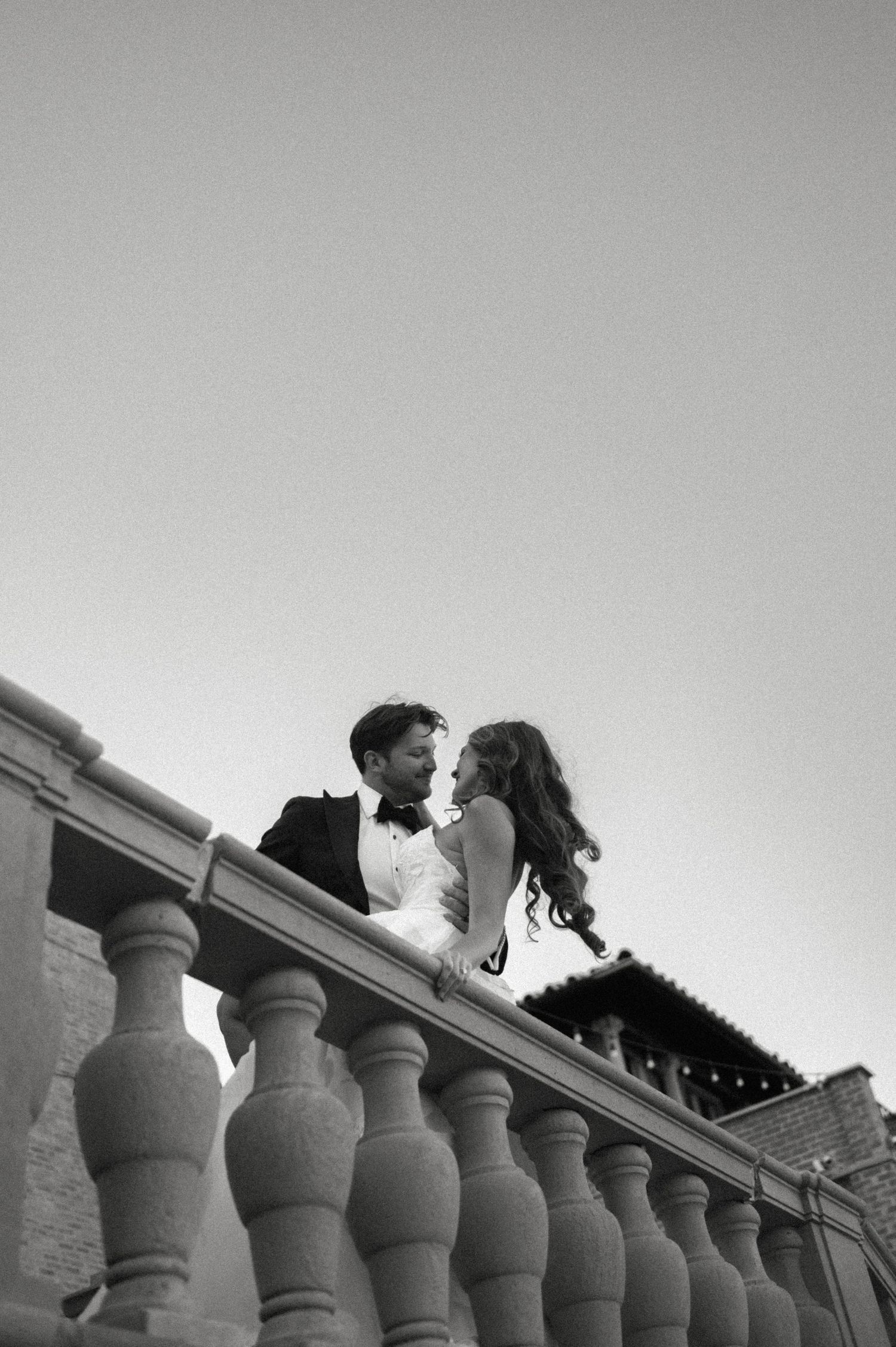 Black and white photo of bride and groom leaning close at Villa Terrace in Milwaukee, Wisconsin.