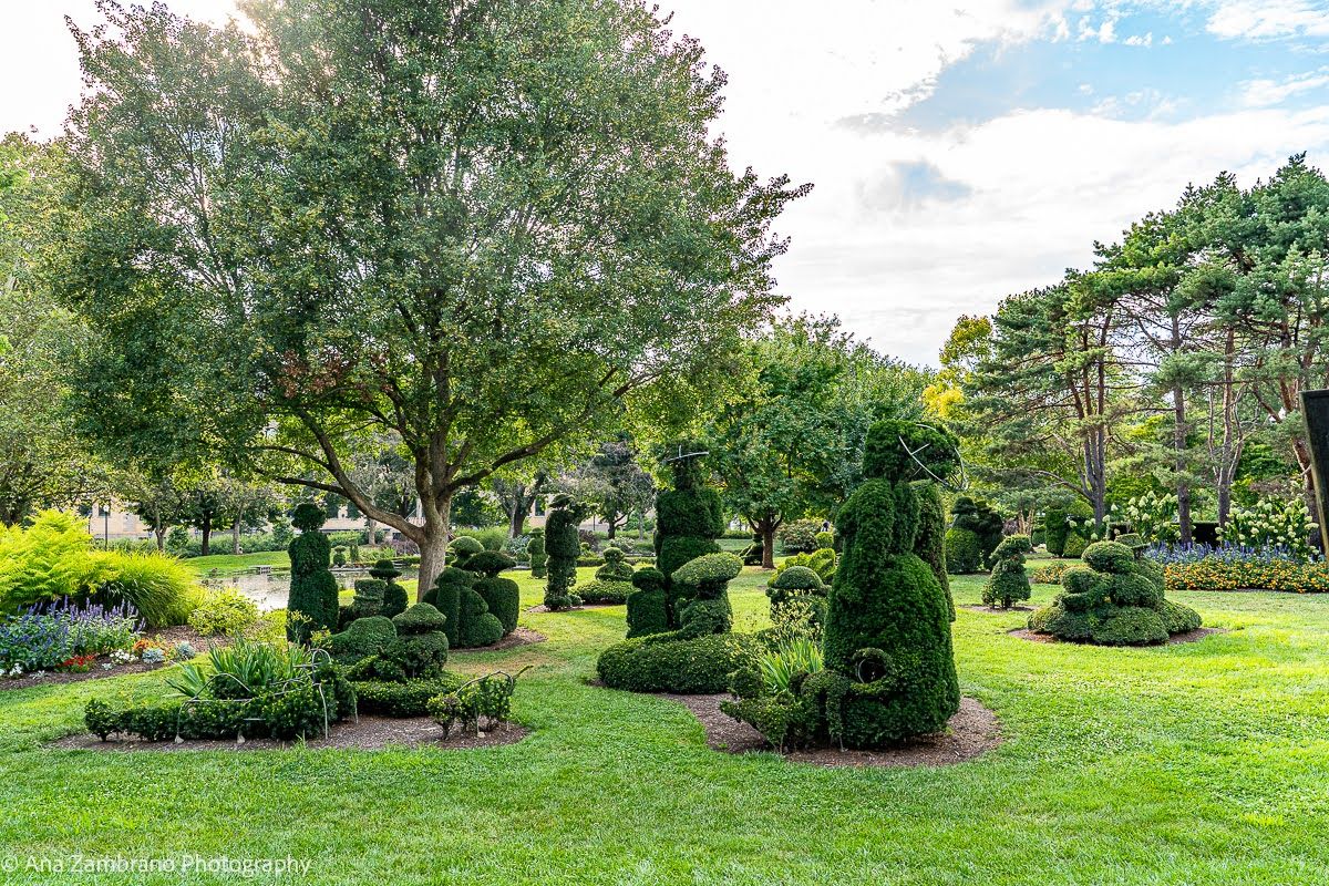 Artistic living topiary sculptures recreating Seurat's painting at The Topiary Park downtown Columbus