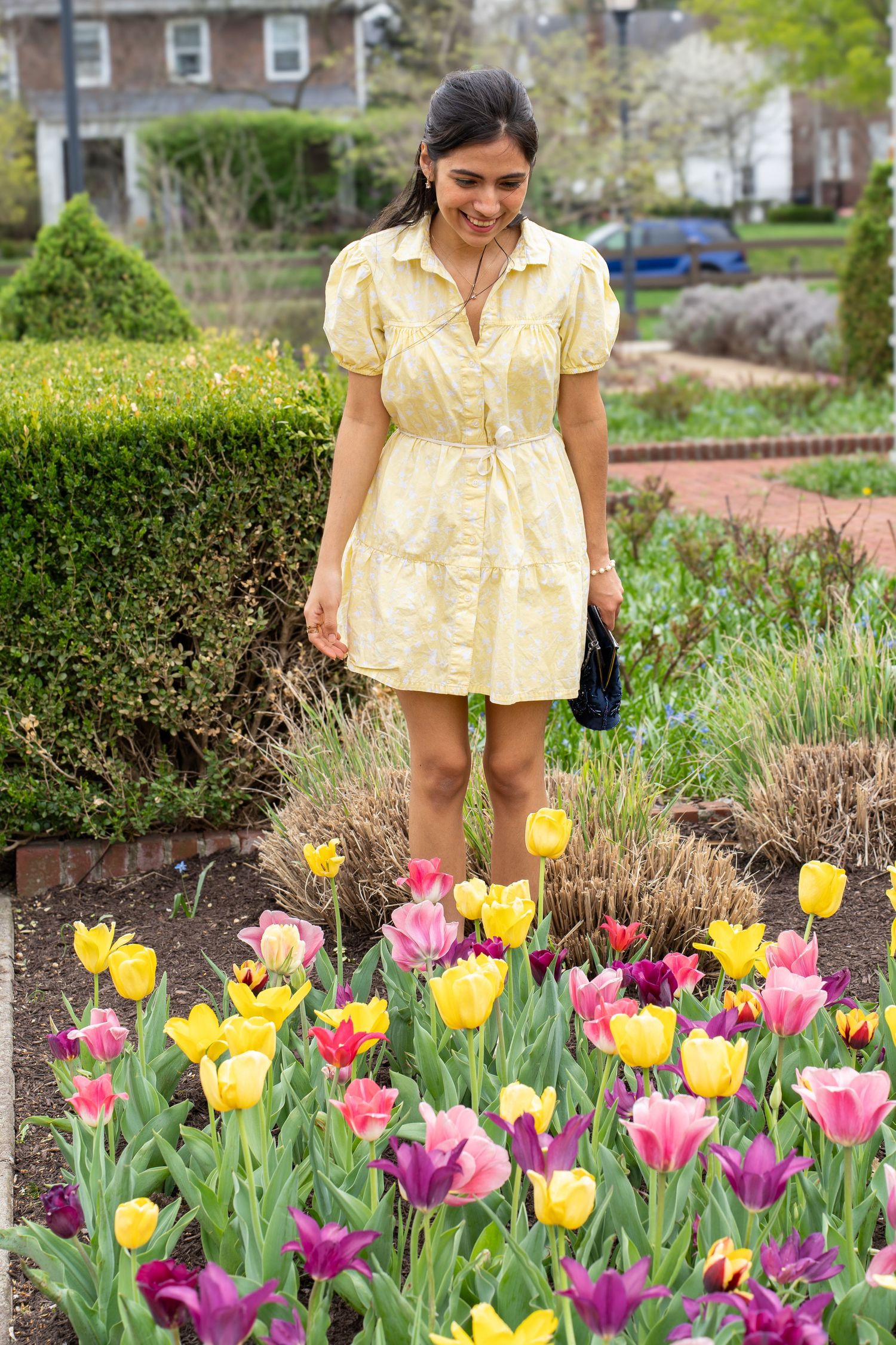 Woman in a yellow dress posing among spring tulips at Franklin Park Conservatory Columbus Ohio