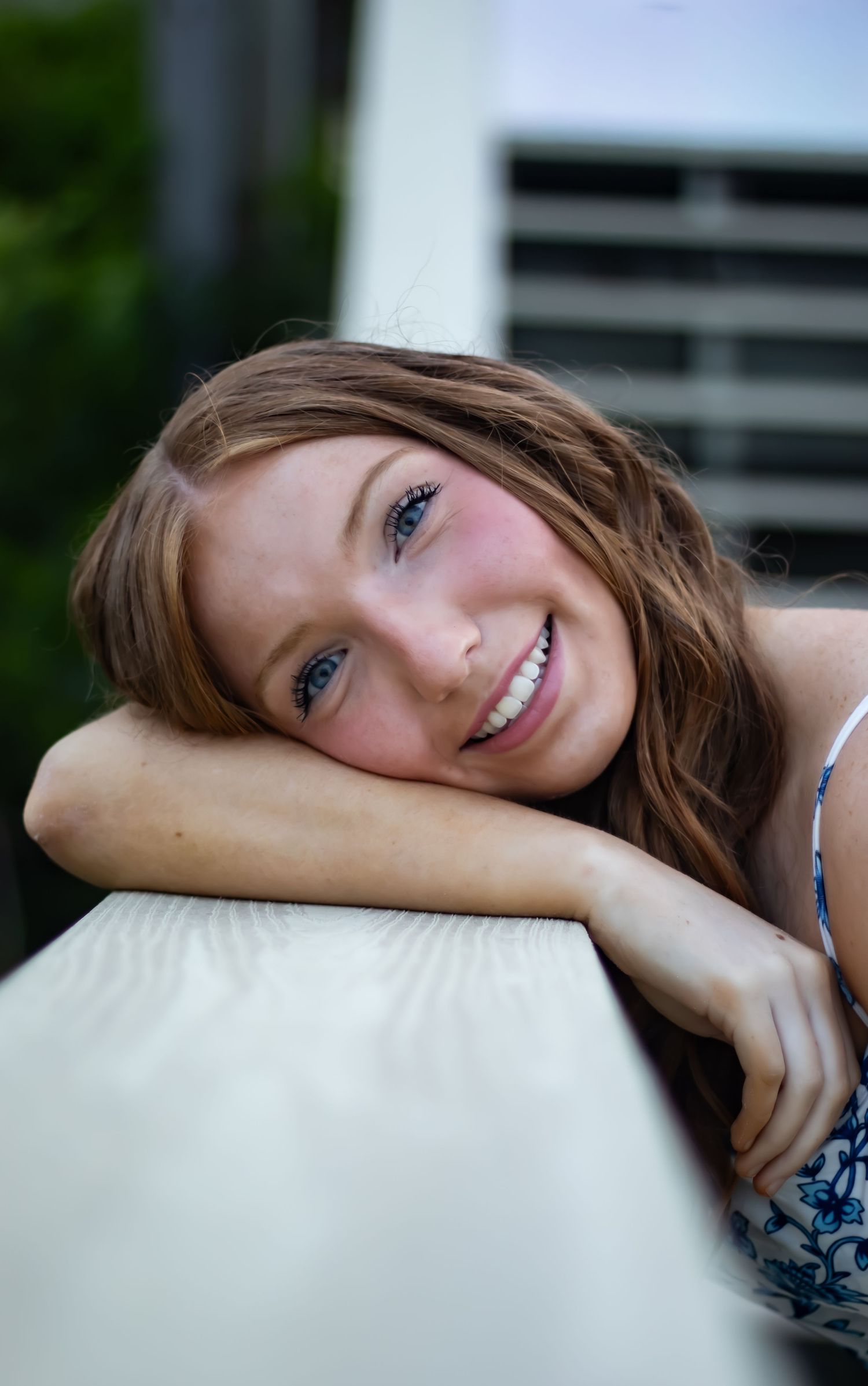 A senior portrait of a girl close up of her face smiling beautifully.