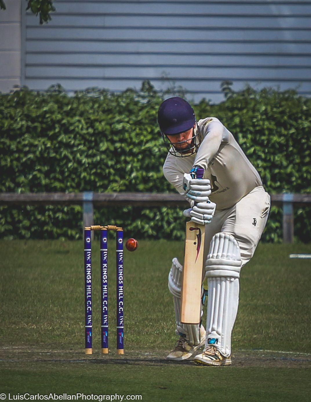 A batsman playing a defensive shot at Kings Hill Cricket Club in Kent, captured during a local match by Luis Carlos Abellan Photography.