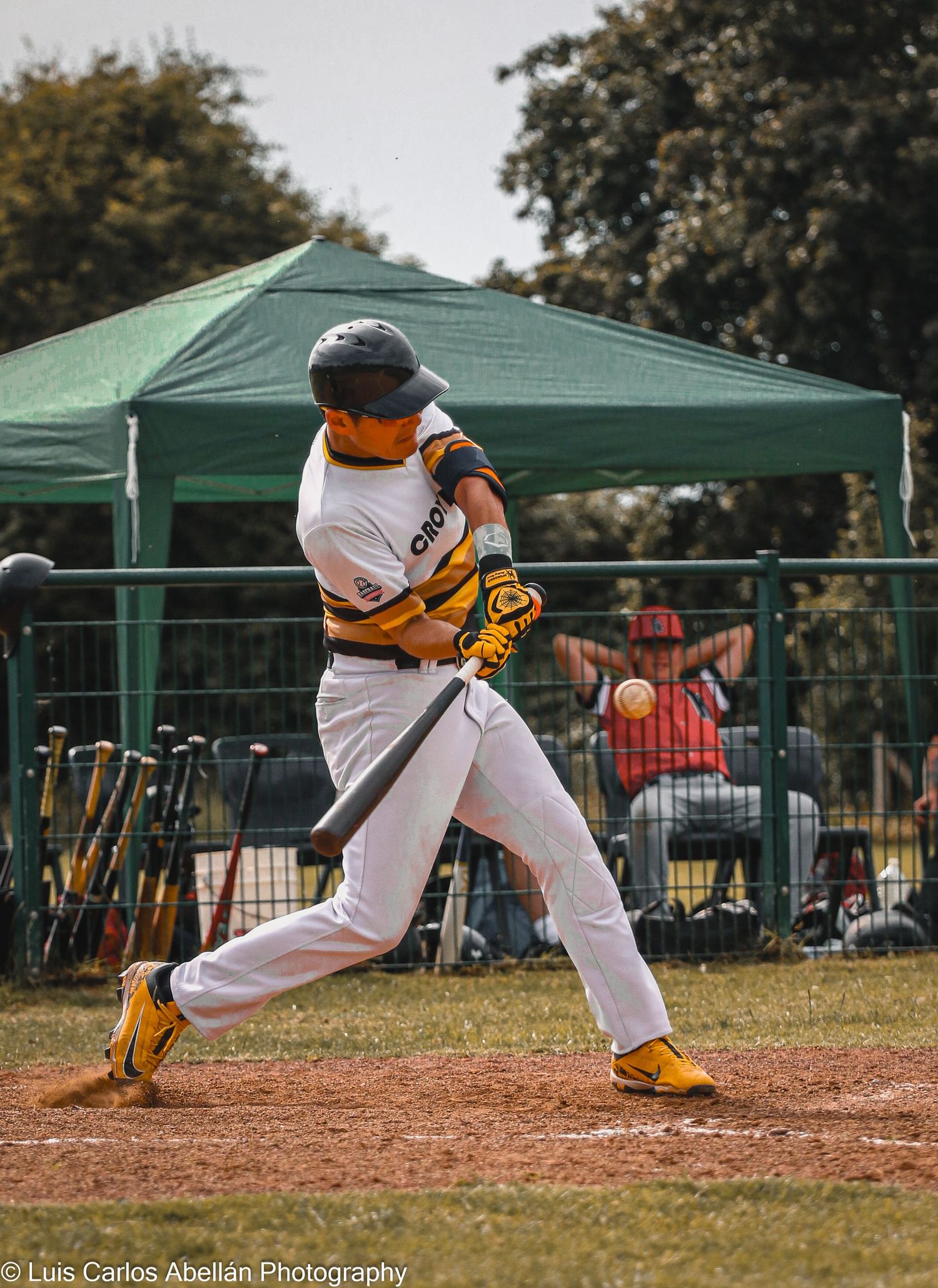 A baseball batter from Croydon swings at a pitch during a game in South East England, shot by Luis Carlos Abellan Photography.