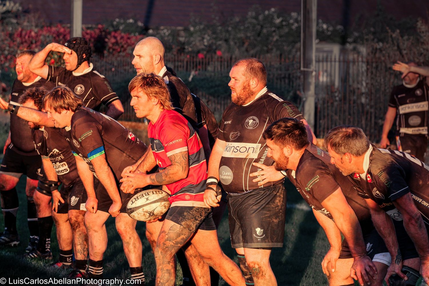 Rugby players forming a line during an intense evening match in Kent, documented by Luis Carlos Abellan Photography.