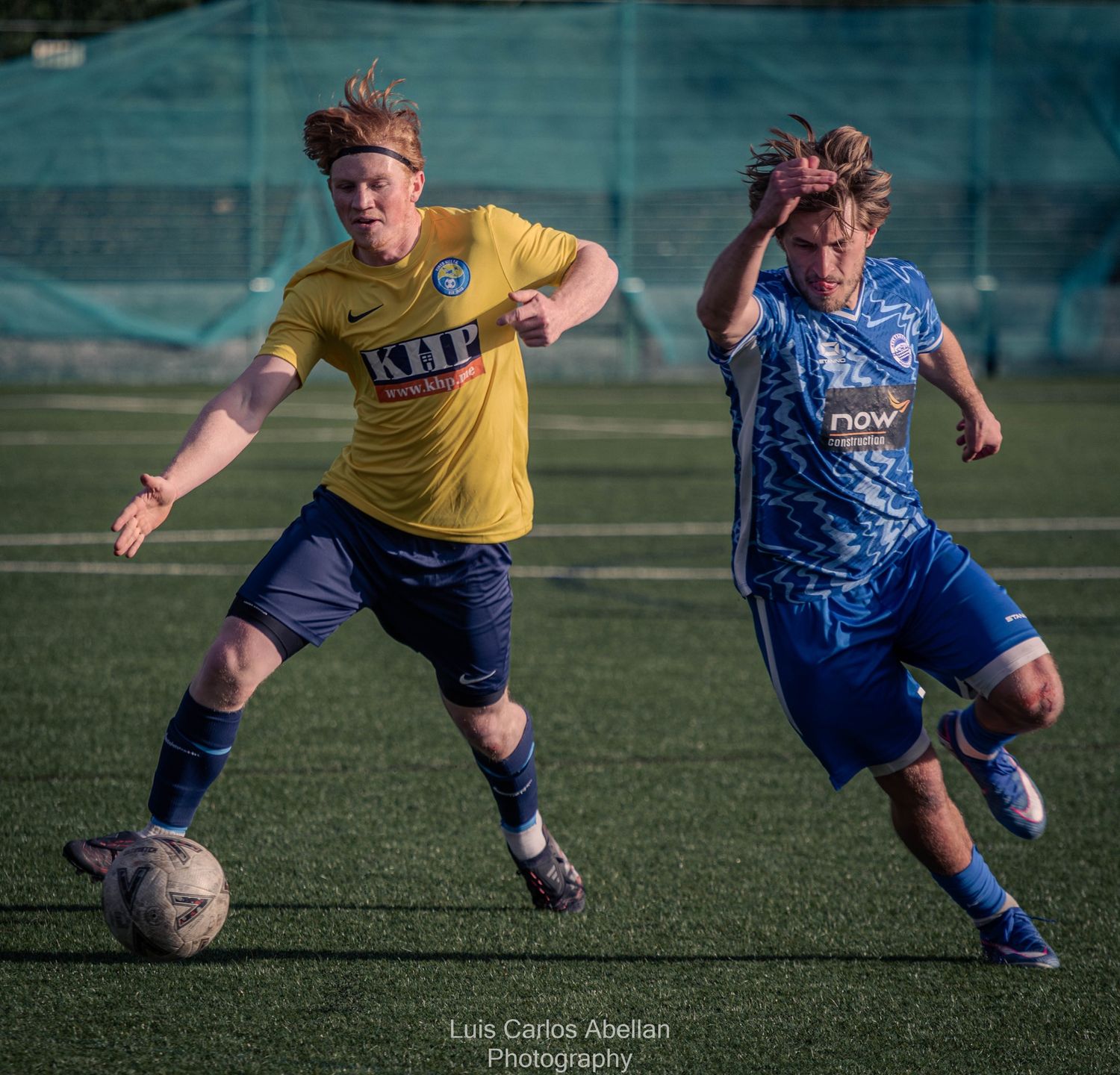 Two footballers competing for possession during a match in Maidstone, professional sports photography by Luis Carlos Abellan.