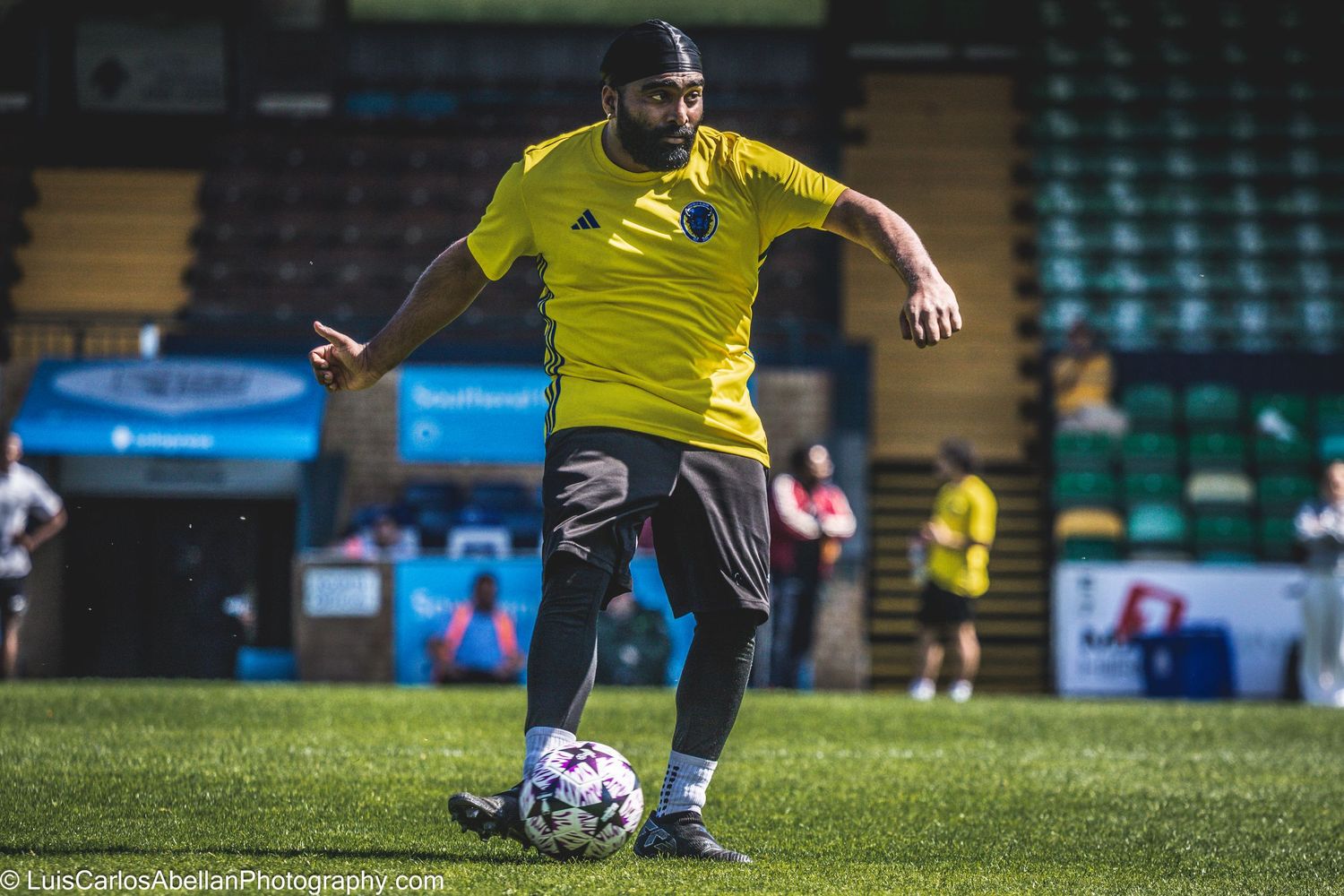 Action shot of an amateur football player controlling the ball during a local match in Kent, captured by Luis Carlos Abellan Photography