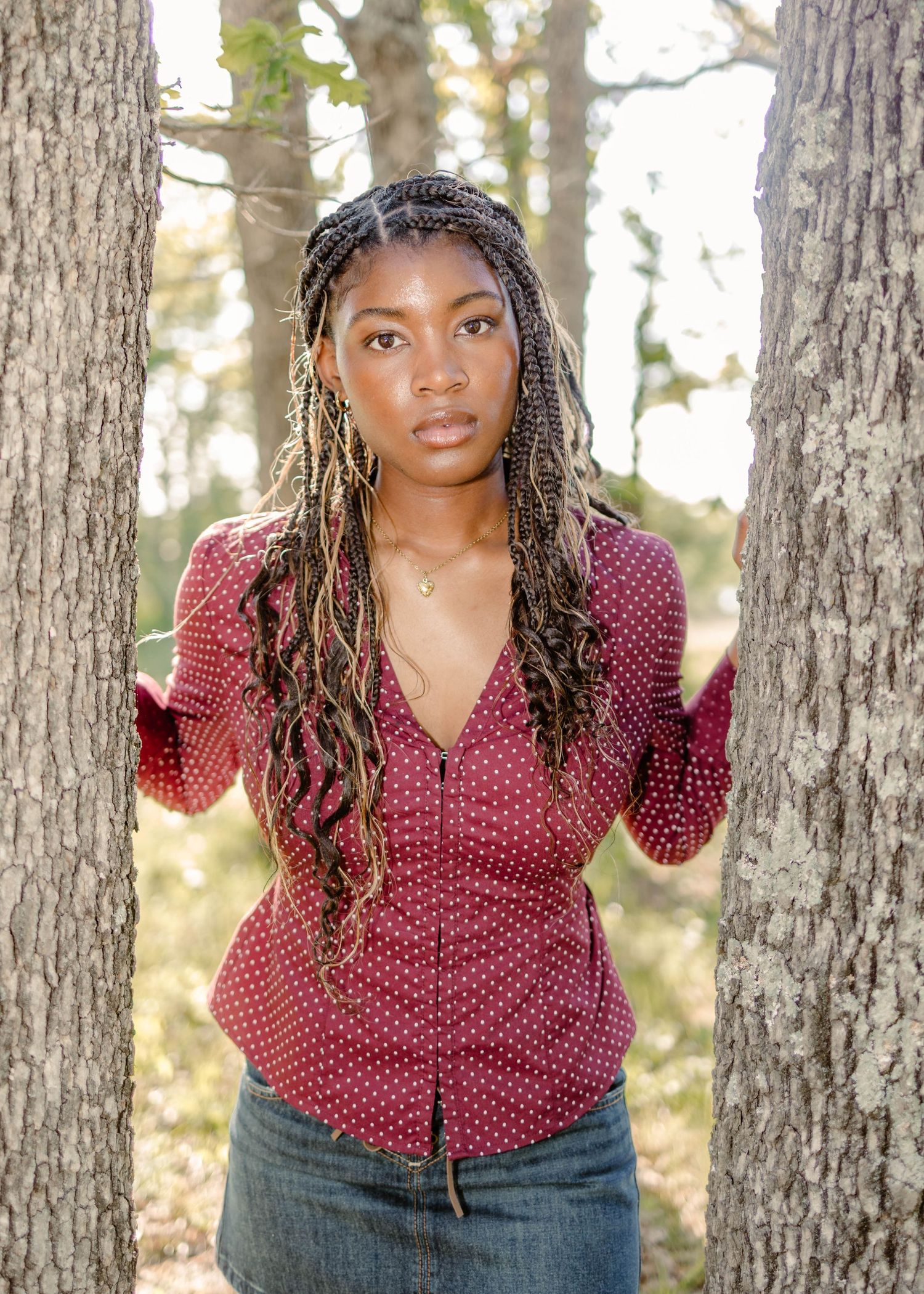 High school senior in red polka dot button up and denim skirt at Bloodline Lake in Ft. Leonard Wood, MO.