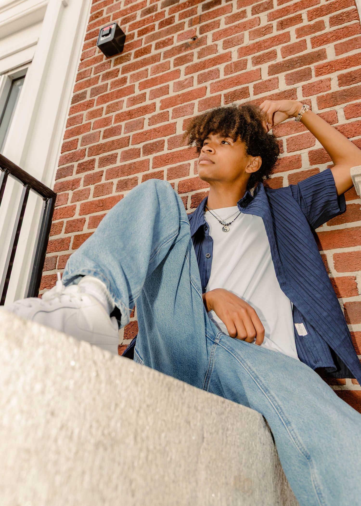 high school senior in blue button down shirt and denim in Rolla, MO for senior photos.