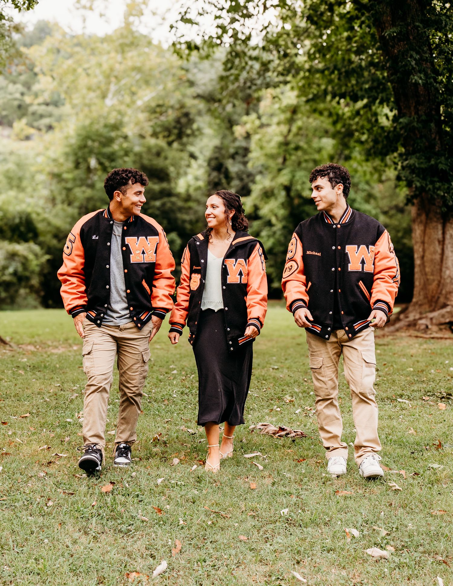 Family and siblings in letterman jackets in a family session in missouri