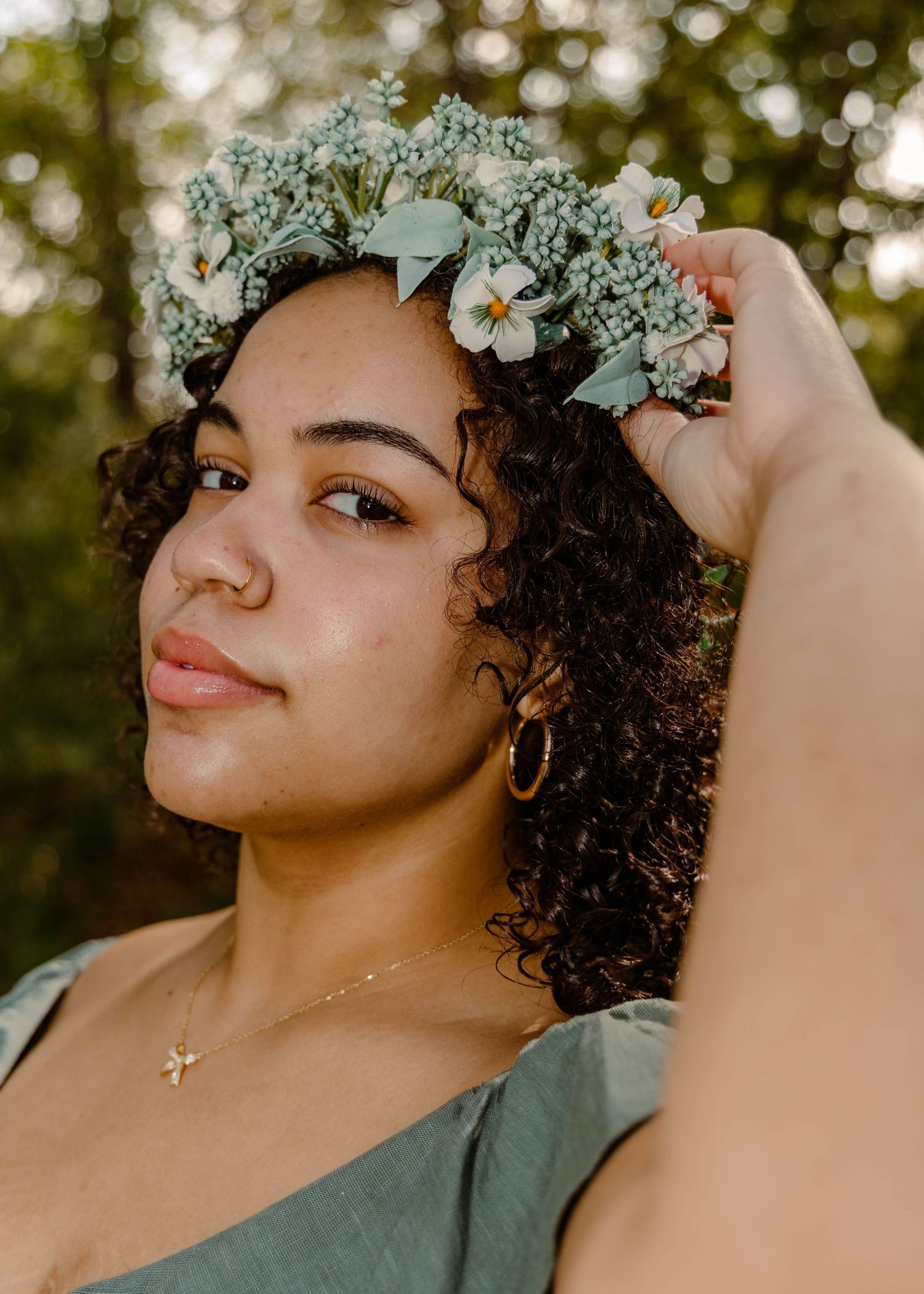 High school senior in a flower crown and sage dress in a photoshoot in Waynesville, MO.