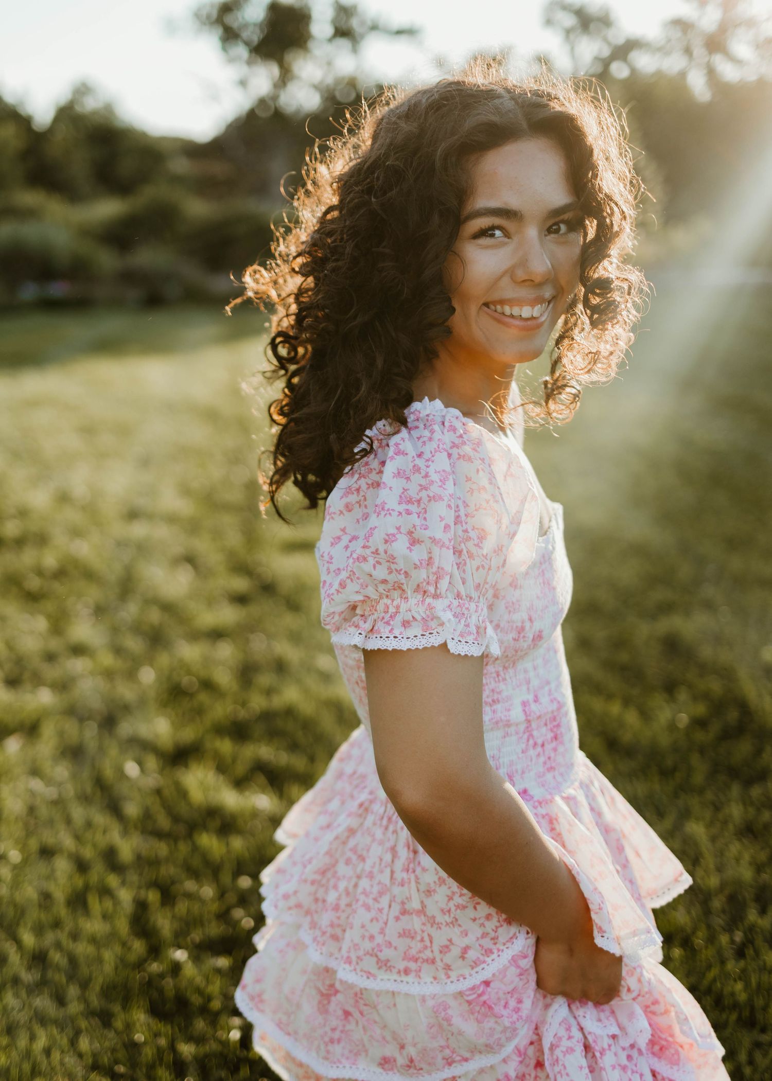 High school senior in a pink floral dress at forest park, in St. Louis mo.