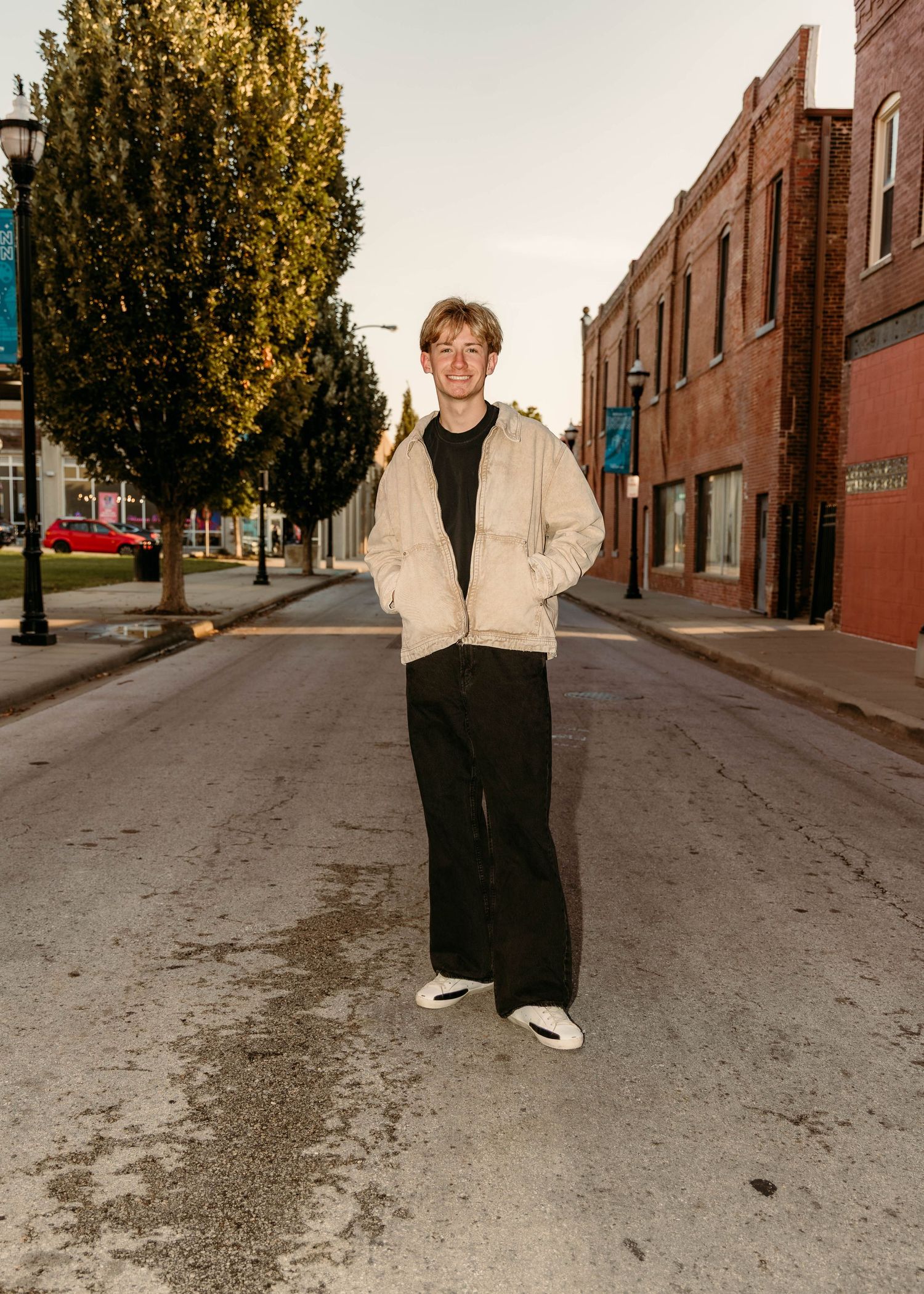 high school senior boy in tan jacket for senior photos in Springfield, MO.