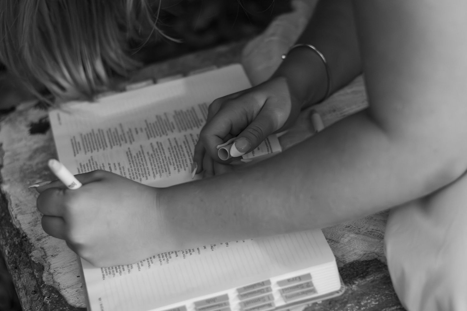 Detail portrait of a white dress and book during an outdoor session