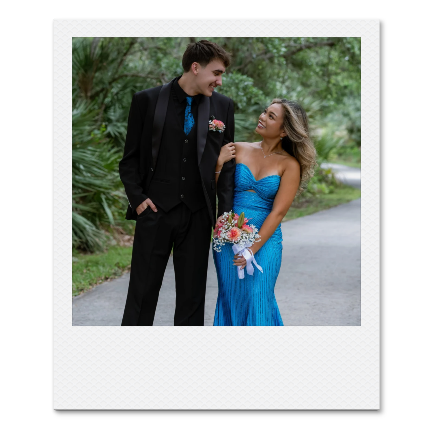 Young couple dressed formally posing together outdoors