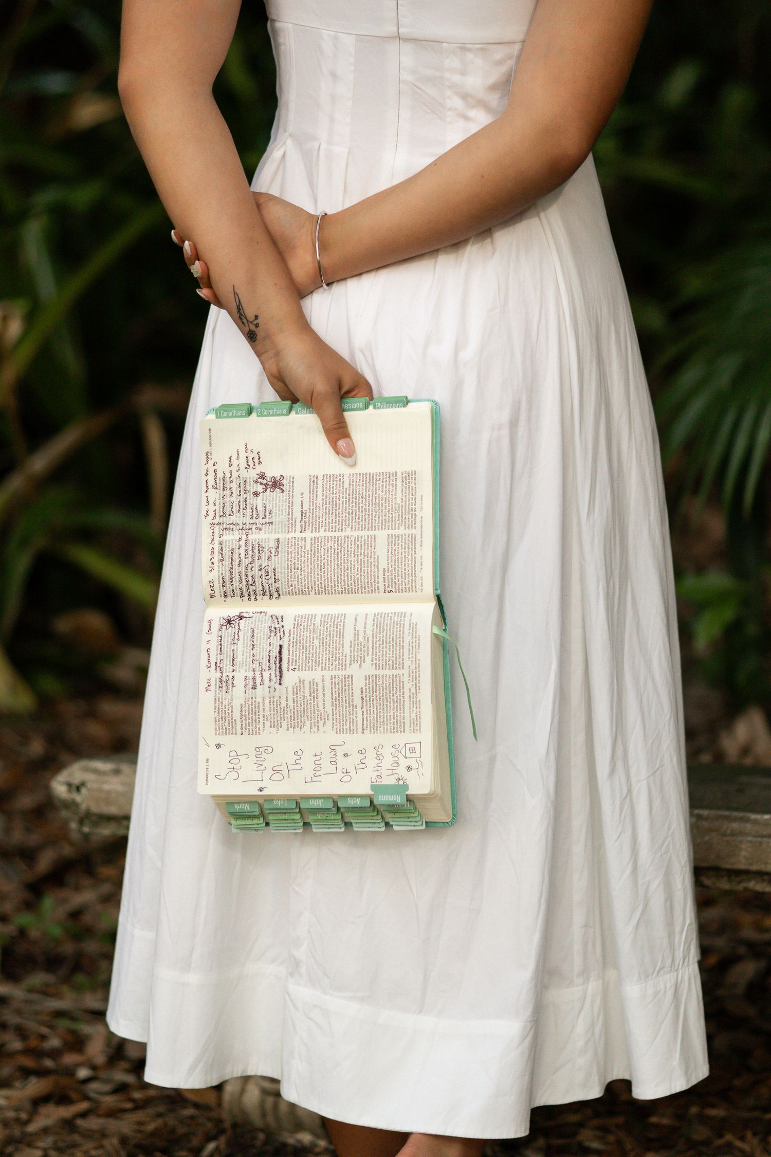 Detail portrait of a white dress and book during an outdoor session