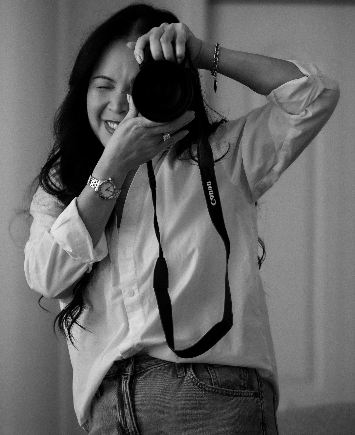 Black-and-white portrait of a photographer holding a camera